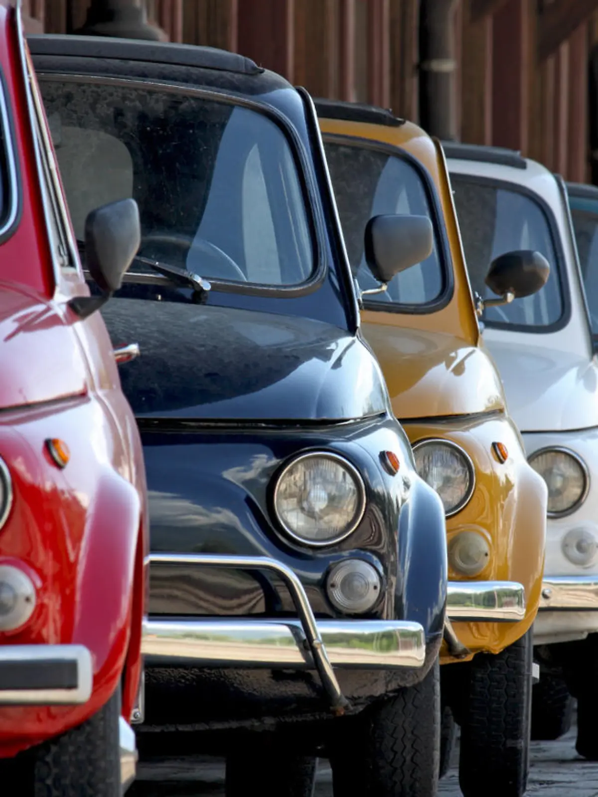 Row of coloured vintage italian cars. They are one of the most popular compact Italian cars produced between '60 and '70.