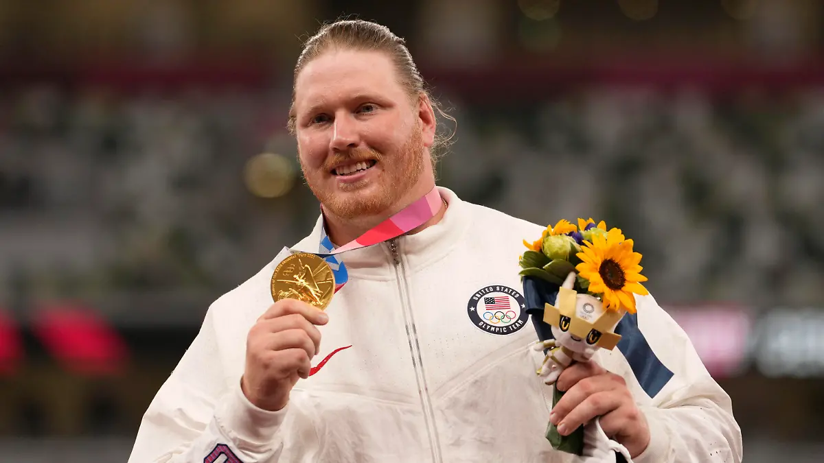 Gold medalist Ryan Crouser, of the United States, poses during the medal ceremony for the men's shot put at the 2020 Summer Olympics, Thursday, Aug. 5, 2021, in Tokyo. (AP Photo/Martin Meissner)