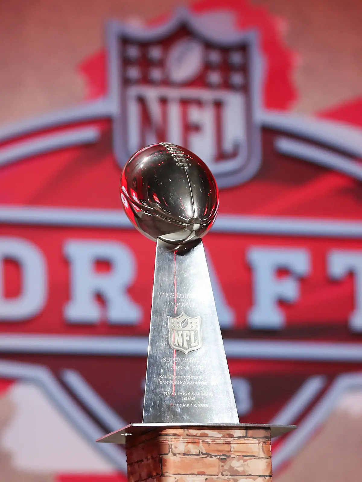 KANSAS CITY, MO - APRIL 27: A view of a Kansas City Chiefs Lombardi Trophy with the NFL, American Football Herren, USA Draft logo in the background during first round of the NFL Draft Red Carpet event on April 27, 2023 at Union Station in Kansas City, MO. Photo by Scott Winters/Icon Sportswire NFL: APR 27 2023 Draft EDITORIAL USE ONLY Icon2304270631