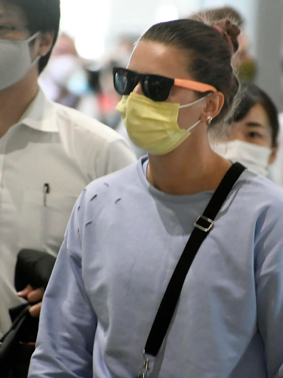 04.08.2021, Japan, Narita: Olympia-Sprinterin Kristina Timanowskaja aus Belarus (M) kommt am internationalen Flughafen Narita östlich von Tokio an. Timanowskaja plant in Europa Zuflucht zu suchen.  Der Fall der Leichtathletin hatte bei den Olympischen Spielen für internationale Empörung gesorgt. Nach Angaben der Athletin wollten belarussische Behörden sie zur vorzeitigen Rückkehr nach Minsk zwingen, weil sie Kritik an Sportfunktionären geübt hatte. Foto: Uncredited/Kyodo News/AP/dpa +++ dpa-Bildfunk +++
