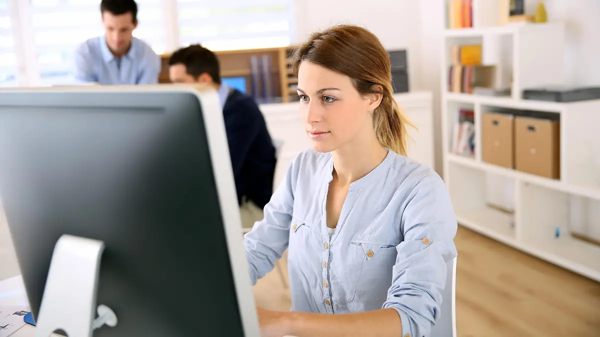 Young woman in office working on desktop