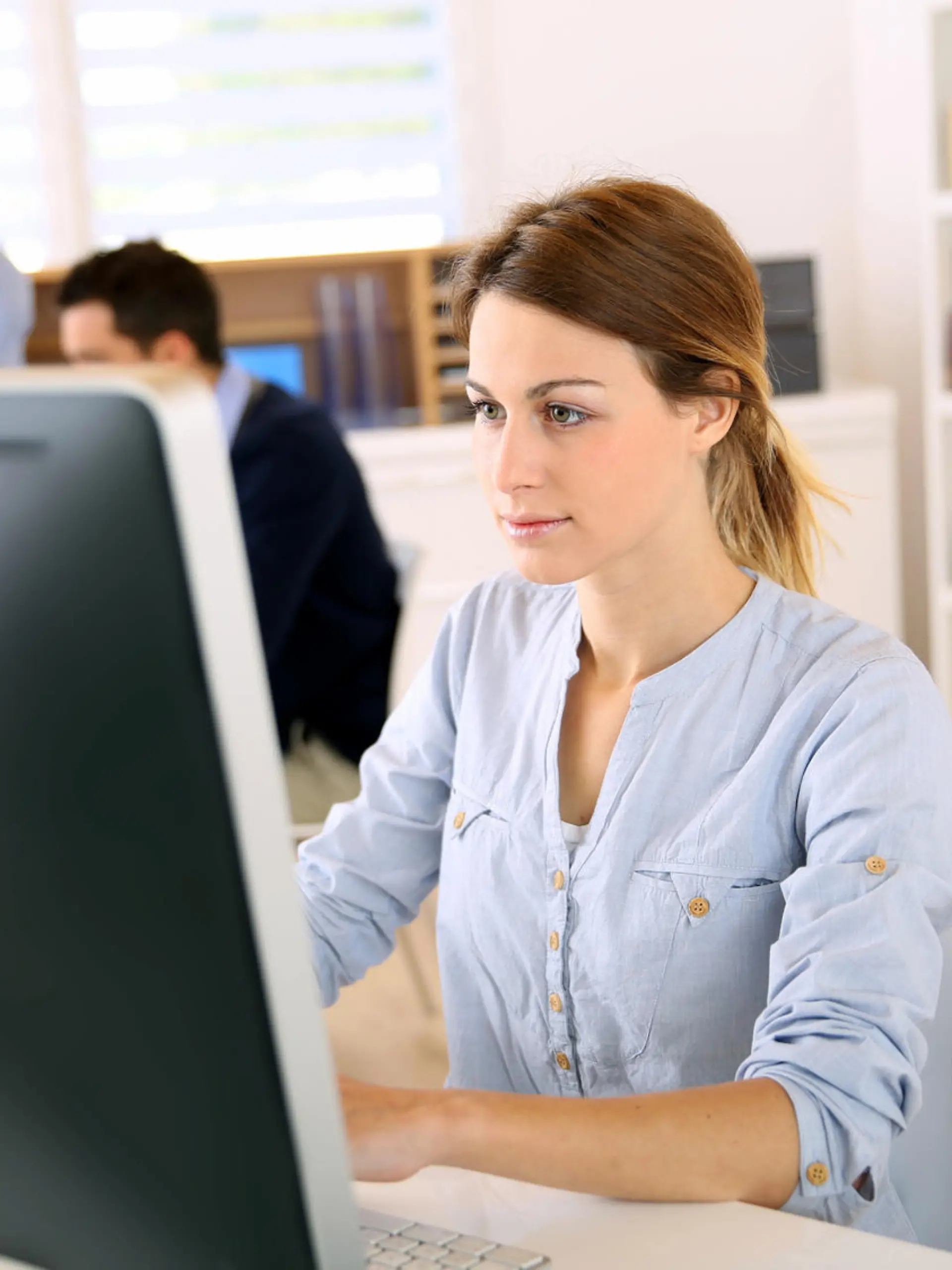 Young woman in office working on desktop