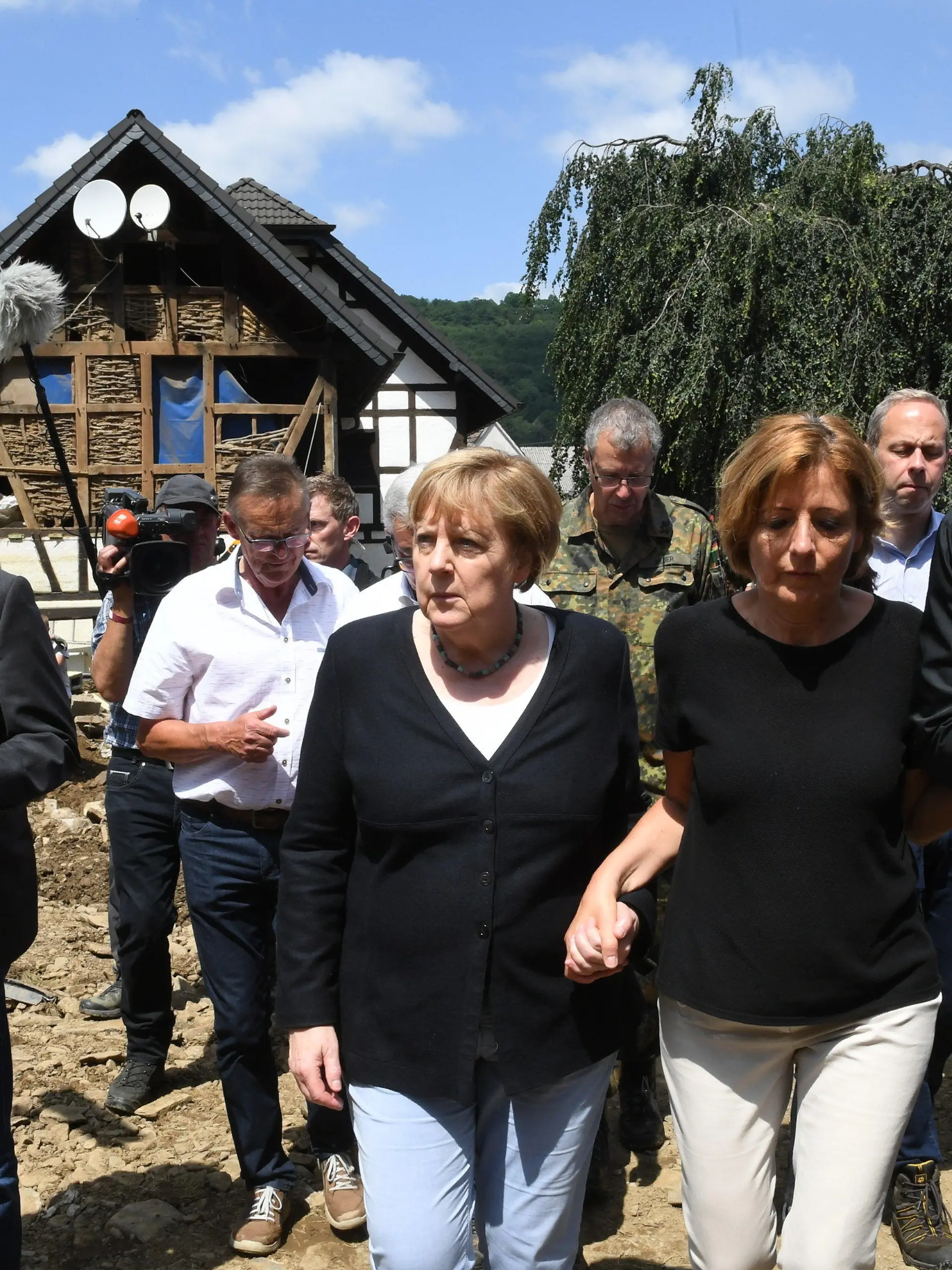 ARCHIV - 18.07.2021, Rheinland-Pfalz, Schuld: Bundeskanzlerin Angela Merkel (3.v.r.) und Malu Dreyer (2.v.r,SPD), Ministerpräsidentin von Rheinland-Pfalz, gehen durch das vom Hochwasser verwüstete Dorf Schuld in der Nähe von Bad Neuenahr-Ahrweiler. (zu dpa Themenpaket zum Ende der Ära Merkel nach der Bundestagswahl) Foto: Christof Stache/POOL AFP/dpa +++ dpa-Bildfunk +++