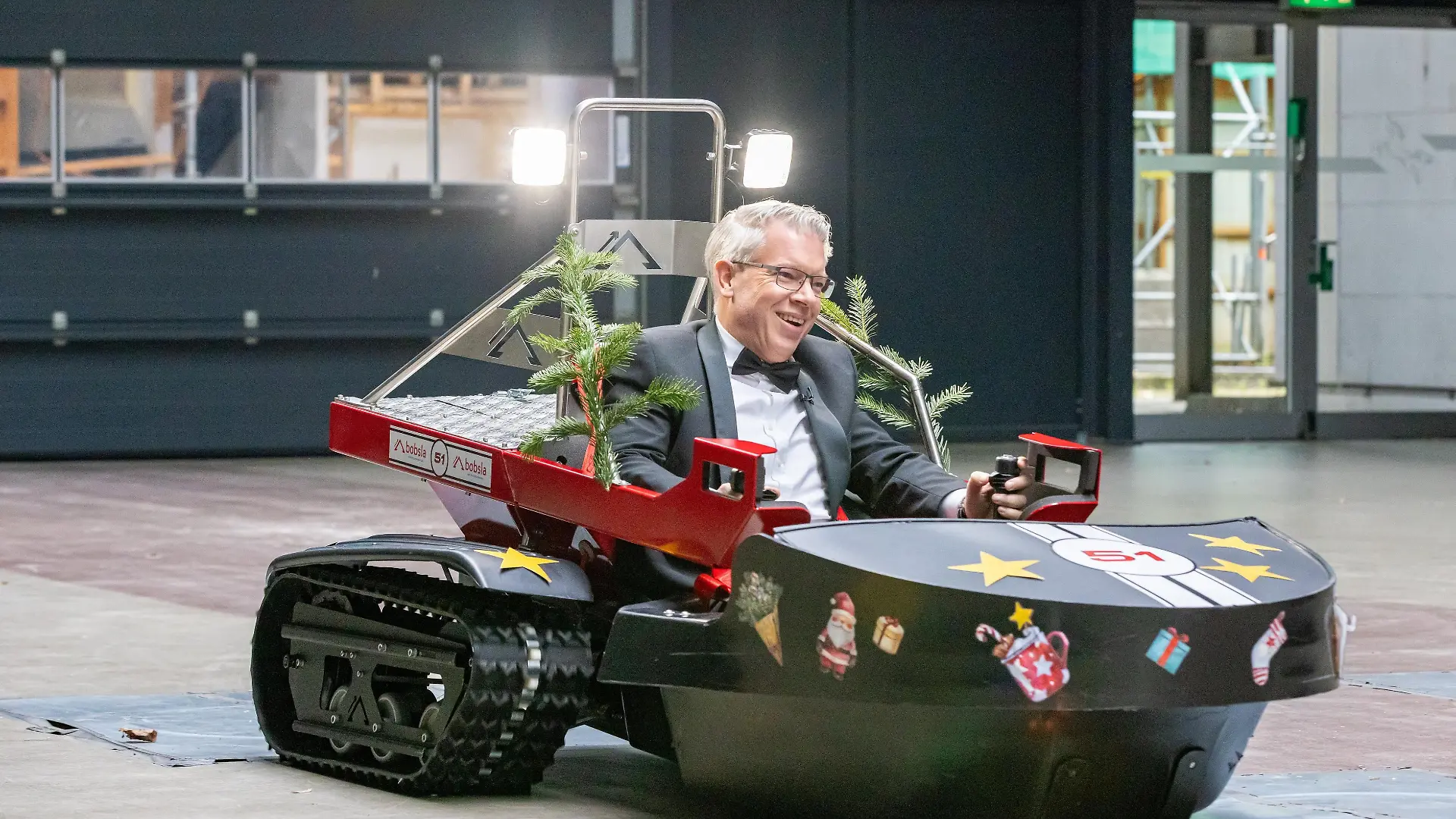 Investor Frank Thelen macht mit dem Elektro-Schneemobil Bobsla vor dem Studio eine Probefahrt.