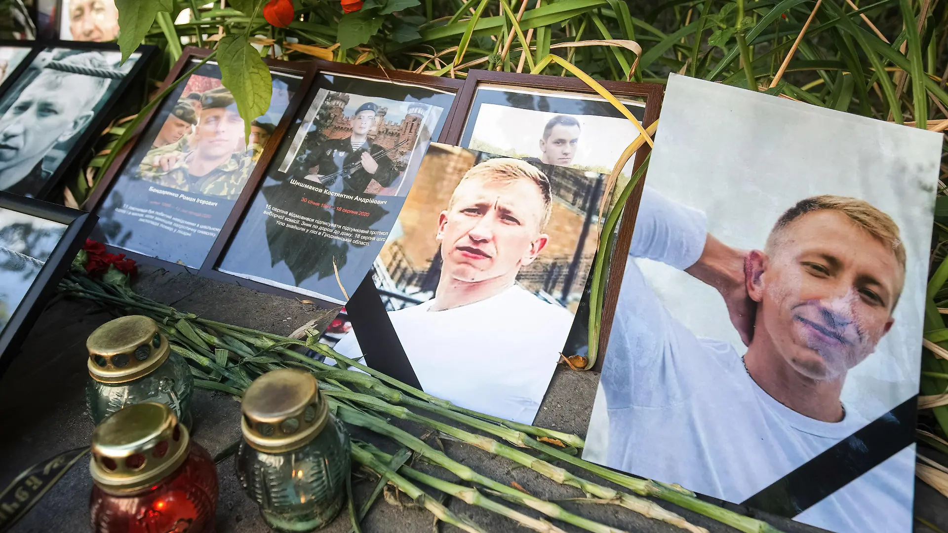 August 3, 2021, Kiev, Ukraine: Flowers and candles are left with photos of Belarusian opposition activist and Head of the Belarusian House in Ukraine Vitaly Shishov outside the Belarus Embassy during a protest in his memory..Belarusian activist Vitaly Shishov was found dead, hanged in a capital park not far from his home, reportedly by national police of Ukraine. Kiev Ukraine - ZUMAs197 20210803_zaa_s197_119 Copyright: xPavloxGoncharx