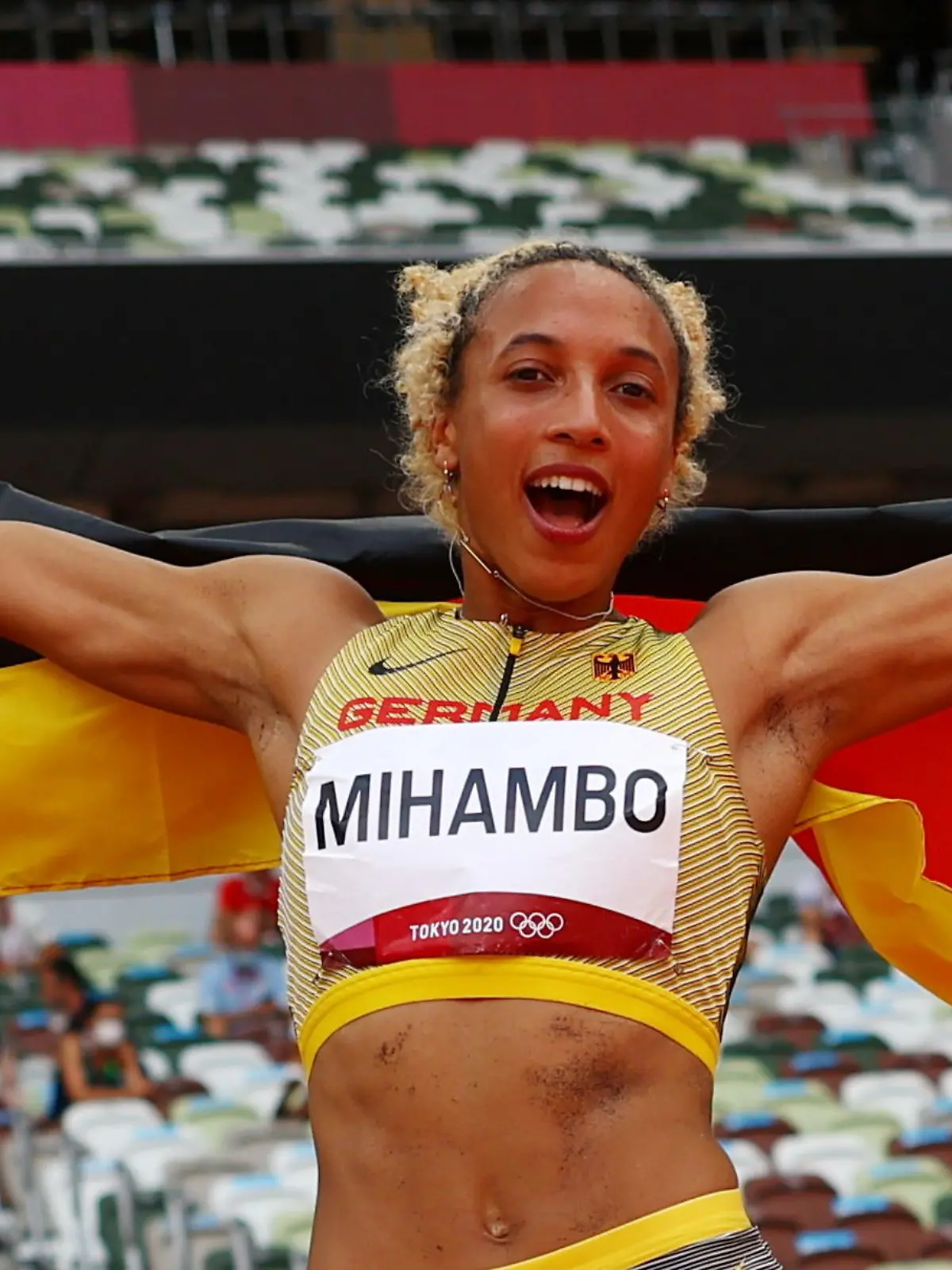 Tokyo 2020 Olympics - Athletics - Women's Long Jump - Final - Olympic Stadium, Tokyo, Japan - August 3, 2021. Malaika Mihambo of Germany celebrates with her national flag after winning gold REUTERS/Kai Pfaffenbach