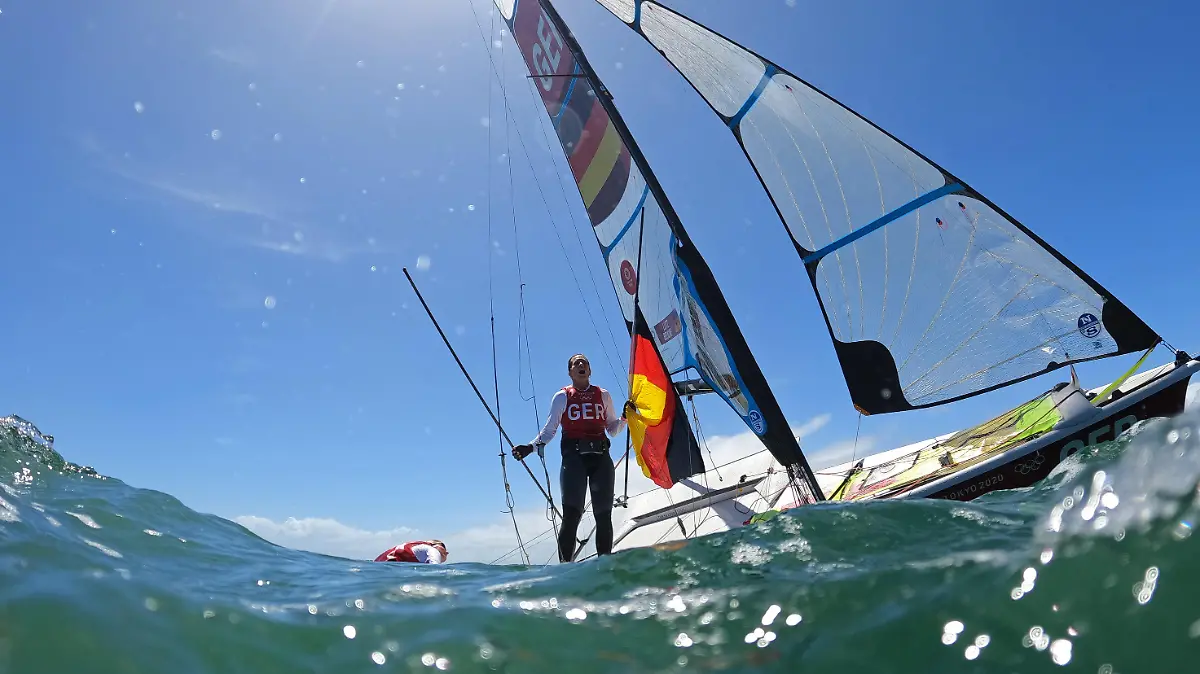 Tokyo 2020 Olympics - Sailing - Women's 49er FX - Medal Race - Enoshima Yacht Harbour - Tokyo, Japan - August 3, 2021. Tina Lutz of Germany and Susann Beucke of Germany jump into the water to celebrate winning silver after the race. REUTERS/Ivan Alvarado