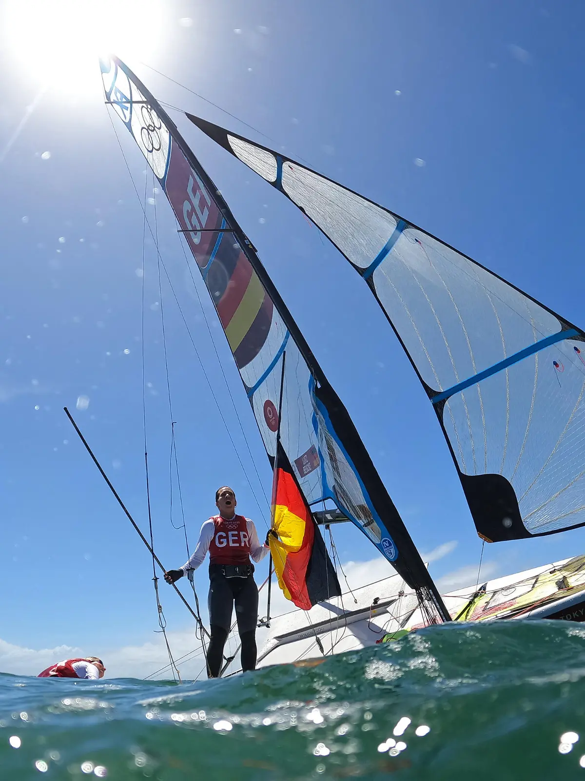 Tokyo 2020 Olympics - Sailing - Women's 49er FX - Medal Race - Enoshima Yacht Harbour - Tokyo, Japan - August 3, 2021. Tina Lutz of Germany and Susann Beucke of Germany jump into the water to celebrate winning silver after the race. REUTERS/Ivan Alvarado