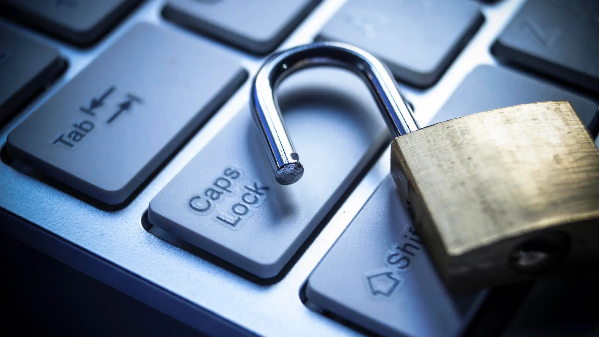 open security lock on computer keyboard - computer security breach concept