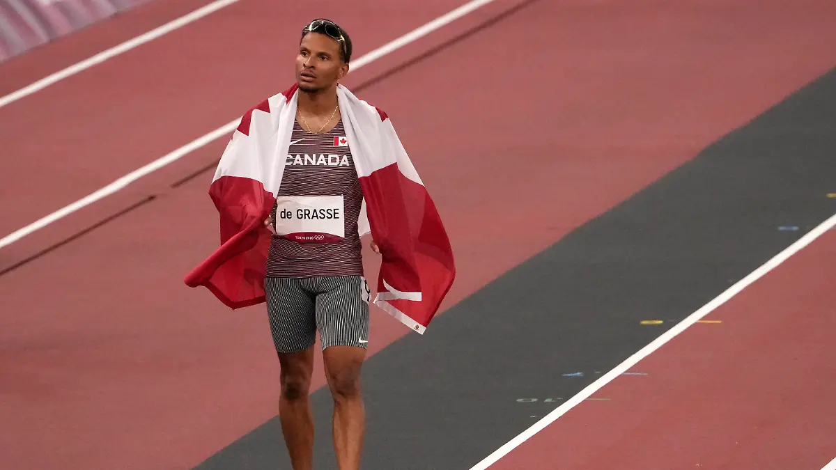 Andre de Grasse, of Canada, bronze, walks on the track after the final of the men's 100-meters at the 2020 Summer Olympics, Sunday, Aug. 1, 2021, in Tokyo, Japan. (AP Photo/Martin Meissner)