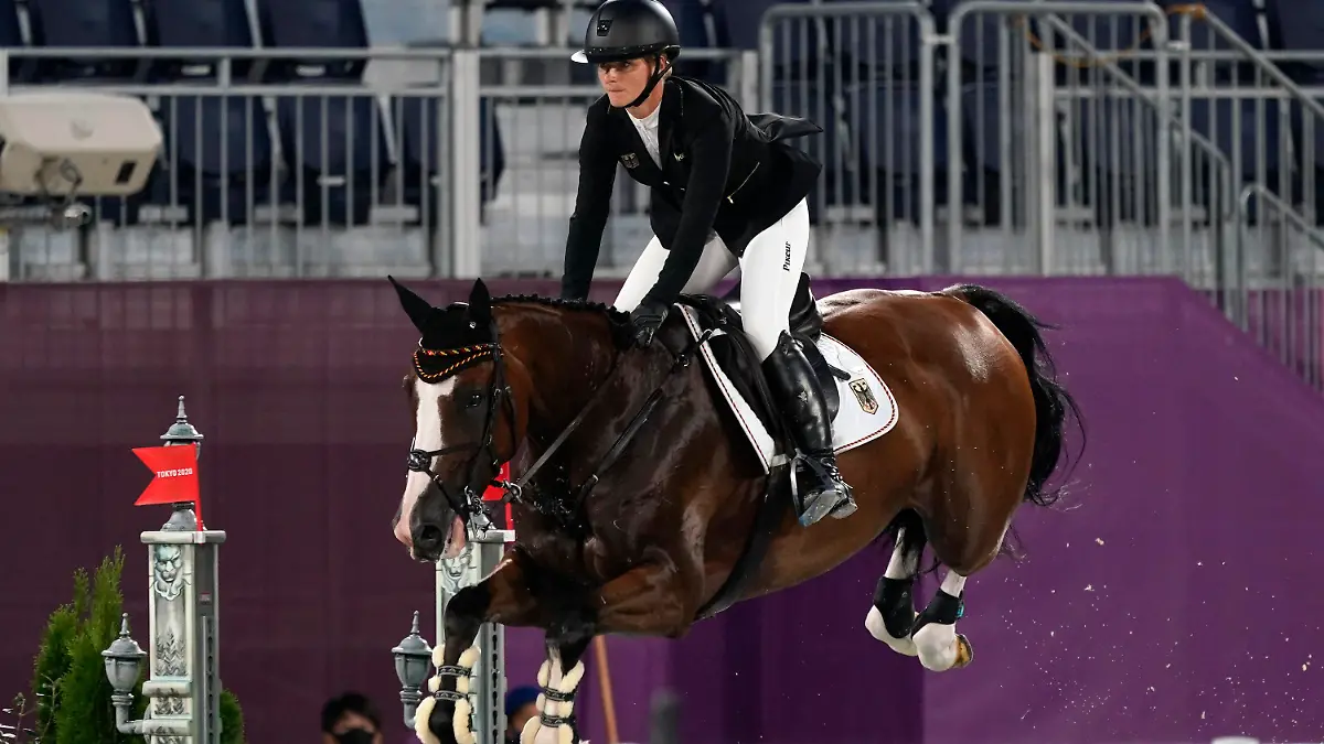 Germany's Julia Krajewski, riding Amande de B'Neville, competes during the equestrian eventing jumping at Equestrian Park in Tokyo at the 2020 Summer Olympics, Monday, Aug. 2, 2021, in Tokyo, Japan. (AP Photo/Carolyn Kaster)