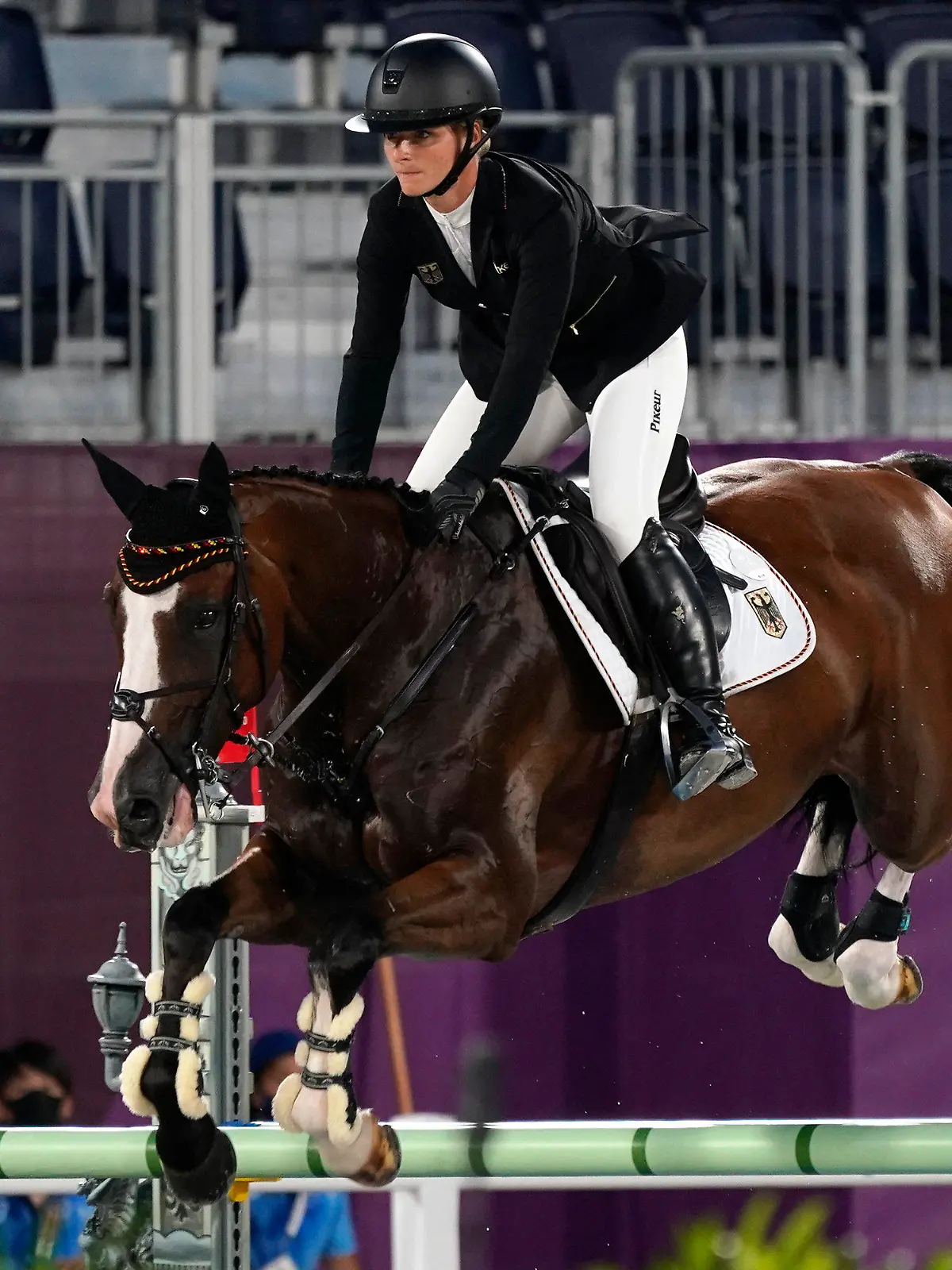 Germany's Julia Krajewski, riding Amande de B'Neville, competes during the equestrian eventing jumping at Equestrian Park in Tokyo at the 2020 Summer Olympics, Monday, Aug. 2, 2021, in Tokyo, Japan. (AP Photo/Carolyn Kaster)