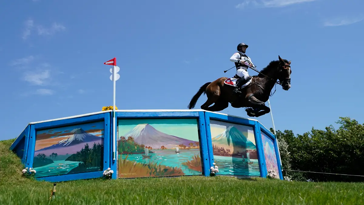 Switzerland's Robin Godel, riding Jet Set, competes during the Equestrian Eventing Cross Country competition at the Sea Forest Cross Country Course during the 2020 Summer Olympics, Sunday, Aug. 1, 2021, in Tokyo, Japan. The Swiss Olympic team says the horse had to be euthanized after sustaining a leg injury in the team eventing competition. (AP Photo/Carolyn Kaster)