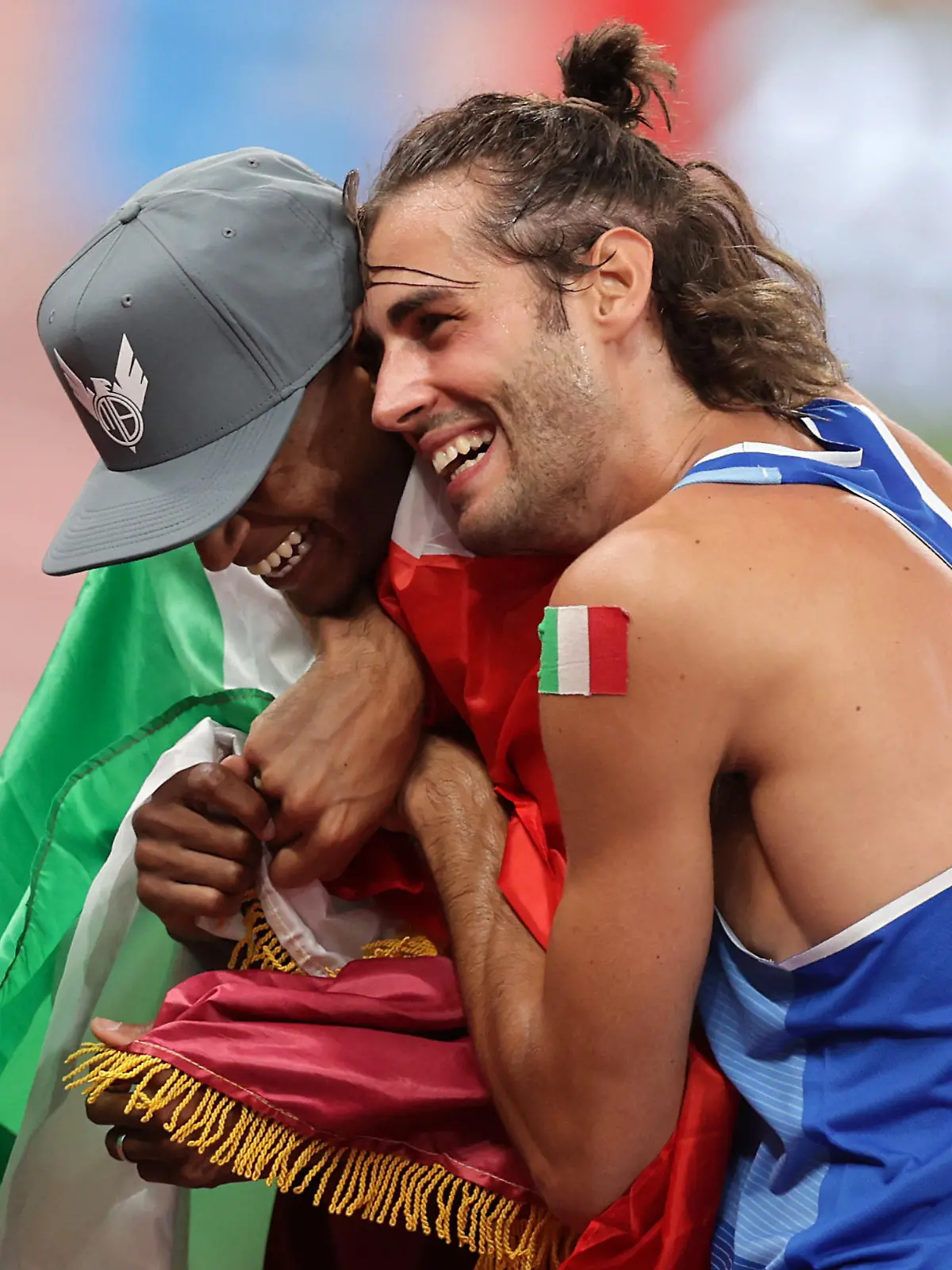 Tokyo 2020 Olympics - Athletics - Men's High Jump - Final- OLS - Olympic Stadium, Tokyo, Japan – August 1, 2021. Mutaz Essa Barshim of Qatar and Gianmarco Tamberi of Italy celebrate after winning gold REUTERS/Hannah Mckay