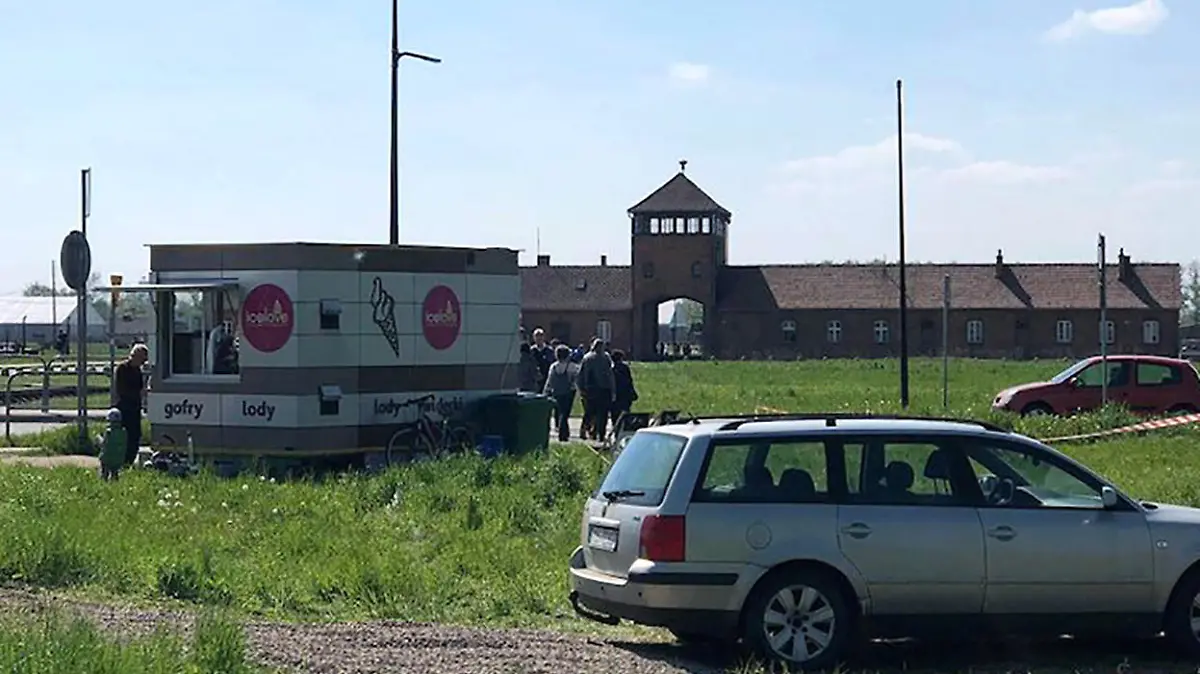 Story from Jam Press (Auschwitz Ice Cream)

Pictured: The ice cream stand set up outside Auschwitz.

Auschwitz visitors slams ice cream stand set up outside Death Gate.

Auschwitz museum visitors have slammed ice creams being sold outside the former concentration camp’s Death Gate.

A van was parked up yards away with an “Ice Love” logo.

It is estimated that 1.1 million Jewish people and other ethnic groups were killed at the Nazi camp, near Krakow, Poland during WW2.

Museum visitors were quick to criticise the location of the van.

Ian Bremmer said: “Maybe Auschwitz isn't the best spot for an ice cream stand.”

Another visitor fumed: “The last thing I'd want after visiting Auschwitz is to be marketed to with an ice cream.

”An ice cream after the horror,” said Franci.

Visitor, Jalananil said: “Sad, some people are losing sense.”

However, one person saw no problem with the business' location.

They said: “What’s wrong with an ice cream stand at Auschwitz?

”It’s summer and it’s hot, why can't people have ice creams?”

A spokesman for the Auschwitz Museum said there is nothing it can do about it as it is on private land.

They said: “This is an example of not only aesthetic tastelessness, but also a lack of respect for a special historical place located nearby.

”However, this trailer is located outside the protection zone of the Monument to the Holocaust, so unfortunately we have no influence on it.”

The spokesperson told the Gazeta Krakowska newspaper: ”We trust that the competent local government authorities will solve this embarrassing problem.”

ENDS