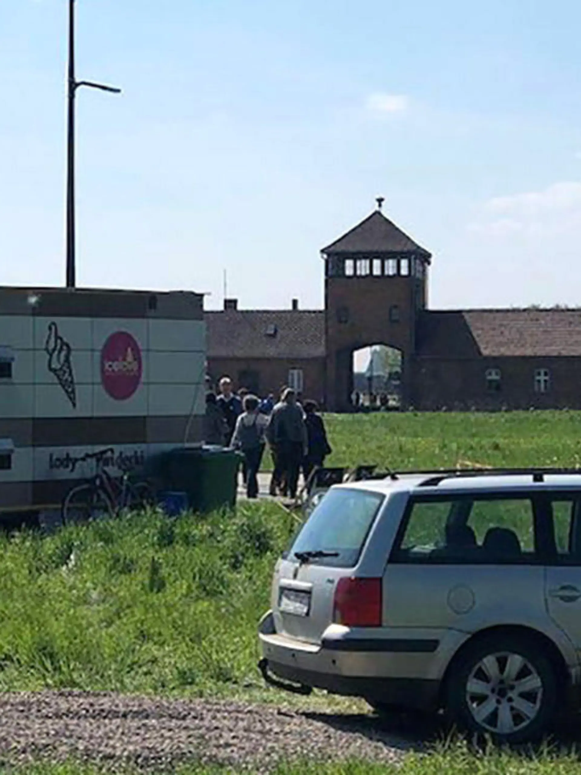 Story from Jam Press (Auschwitz Ice Cream)

Pictured: The ice cream stand set up outside Auschwitz.

Auschwitz visitors slams ice cream stand set up outside Death Gate.

Auschwitz museum visitors have slammed ice creams being sold outside the former concentration camp’s Death Gate.

A van was parked up yards away with an “Ice Love” logo.

It is estimated that 1.1 million Jewish people and other ethnic groups were killed at the Nazi camp, near Krakow, Poland during WW2.

Museum visitors were quick to criticise the location of the van.

Ian Bremmer said: “Maybe Auschwitz isn't the best spot for an ice cream stand.”

Another visitor fumed: “The last thing I'd want after visiting Auschwitz is to be marketed to with an ice cream.

”An ice cream after the horror,” said Franci.

Visitor, Jalananil said: “Sad, some people are losing sense.”

However, one person saw no problem with the business' location.

They said: “What’s wrong with an ice cream stand at Auschwitz?

”It’s summer and it’s hot, why can't people have ice creams?”

A spokesman for the Auschwitz Museum said there is nothing it can do about it as it is on private land.

They said: “This is an example of not only aesthetic tastelessness, but also a lack of respect for a special historical place located nearby.

”However, this trailer is located outside the protection zone of the Monument to the Holocaust, so unfortunately we have no influence on it.”

The spokesperson told the Gazeta Krakowska newspaper: ”We trust that the competent local government authorities will solve this embarrassing problem.”

ENDS