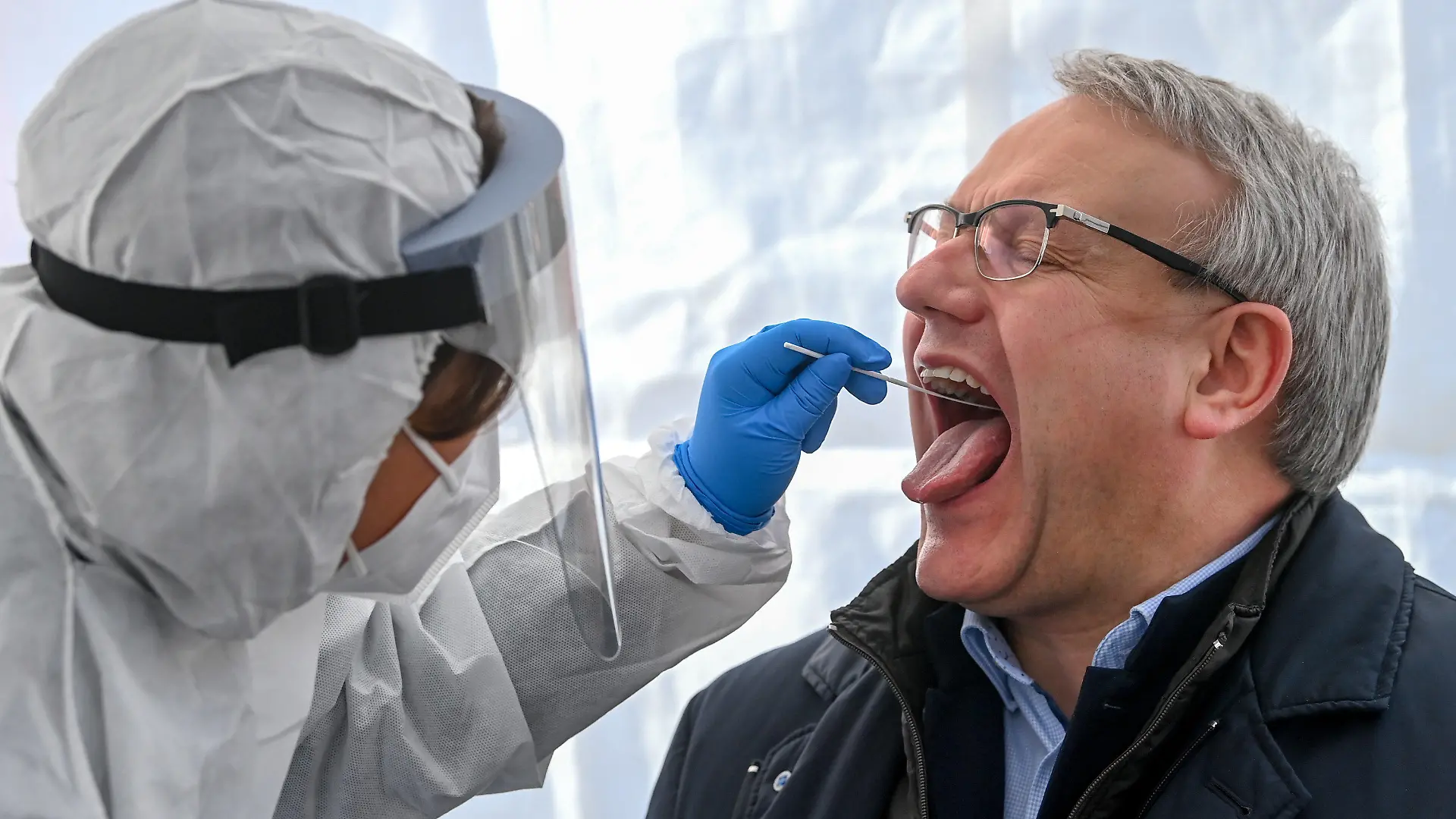 23.02.2021, Sachsen-Anhalt, Naumburg: Götz Ulrich (CDU), Landrat des Burgenlandkreises, lässt sich in einem Zelt auf dem Markt mit einem Schnelltest auf Corona testen. Vom 23. bis 28.02.2021 können sich hier alle Einwohnerinnen und Einwohner des Burgenlandkreises kostenfrei testen lassen. Die Schnelltest werden vor Ort ausgewertet, bei einem positiven Ergebnis schließt sich umgehend ein Laborstest an, der auch auf Virus-Mutationen untersucht wird. Foto: Hendrik Schmidt/dpa-Zentralbild/dpa +++ dpa-Bildfunk +++