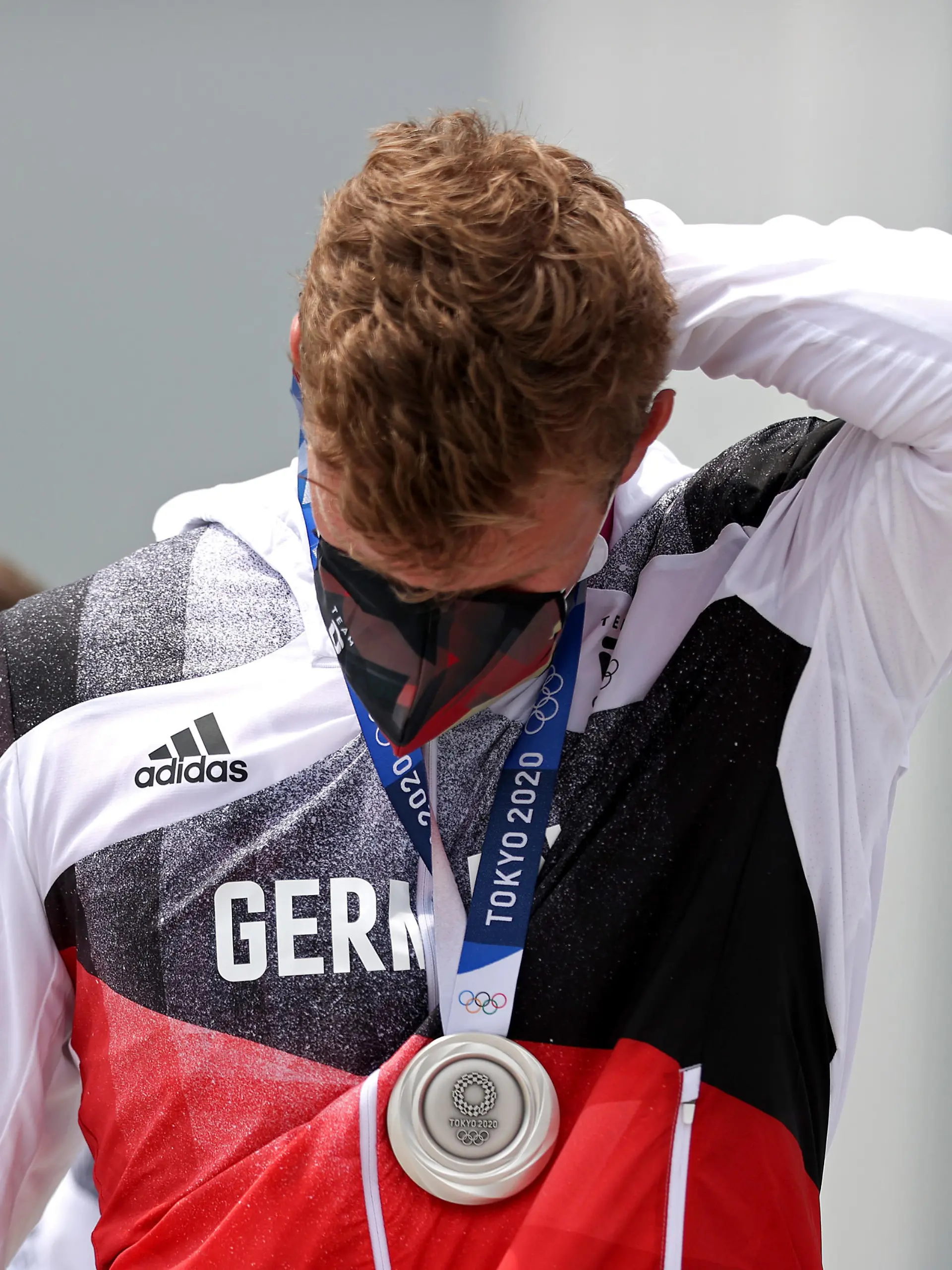 TOKYO, JAPAN - JULY 30:   Silver medalist Hannes Ocik of Team Germany reacts following the medal ceremony for the Men's Eight Final A on day seven of the Tokyo 2020 Olympic Games at Sea Forest Waterway on July 30, 2021 in Tokyo, Japan. (Photo by Naomi Baker/Getty Images)