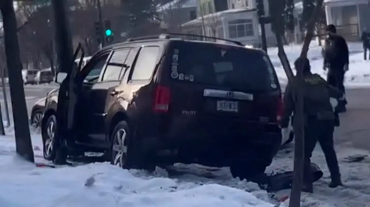 Members of U.S. Immigration and Customs Enforcement (ICE) respond at the scene where a woman was shot in Minneapolis