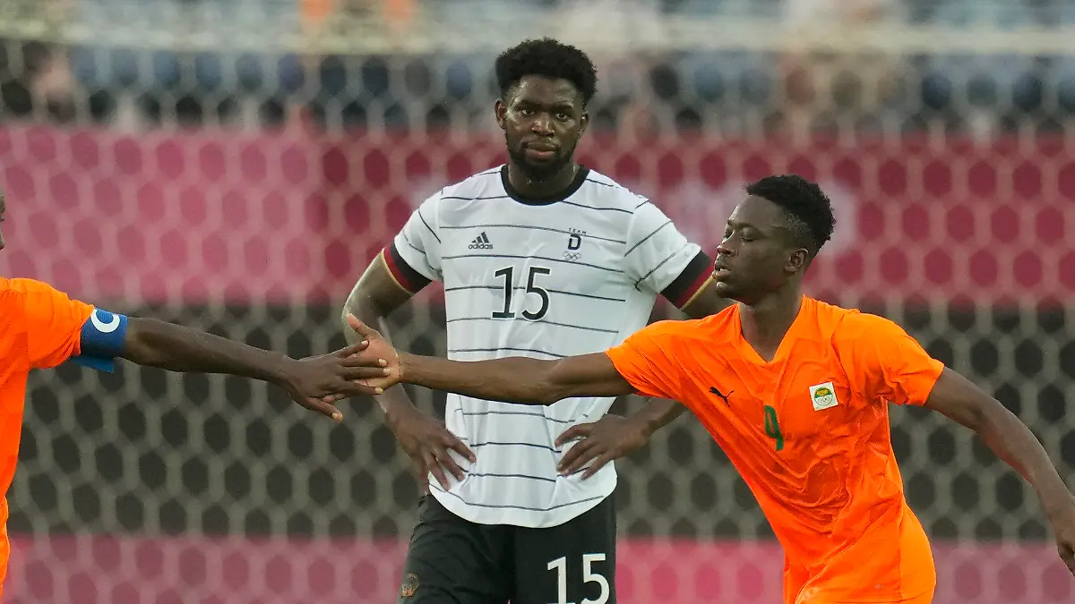 Ivory Coast's Max Gradel, left, and Youssouf Dao, right, celebrate after Germany's Benjamin Henrichs scored an own goal during a men's soccer match at the 2020 Summer Olympics, Wednesday, July 28, 2021, in Rifu, Japan. Germany's Jordan Torunarigha (15) looks on. (AP Photo/Andre Penner)
