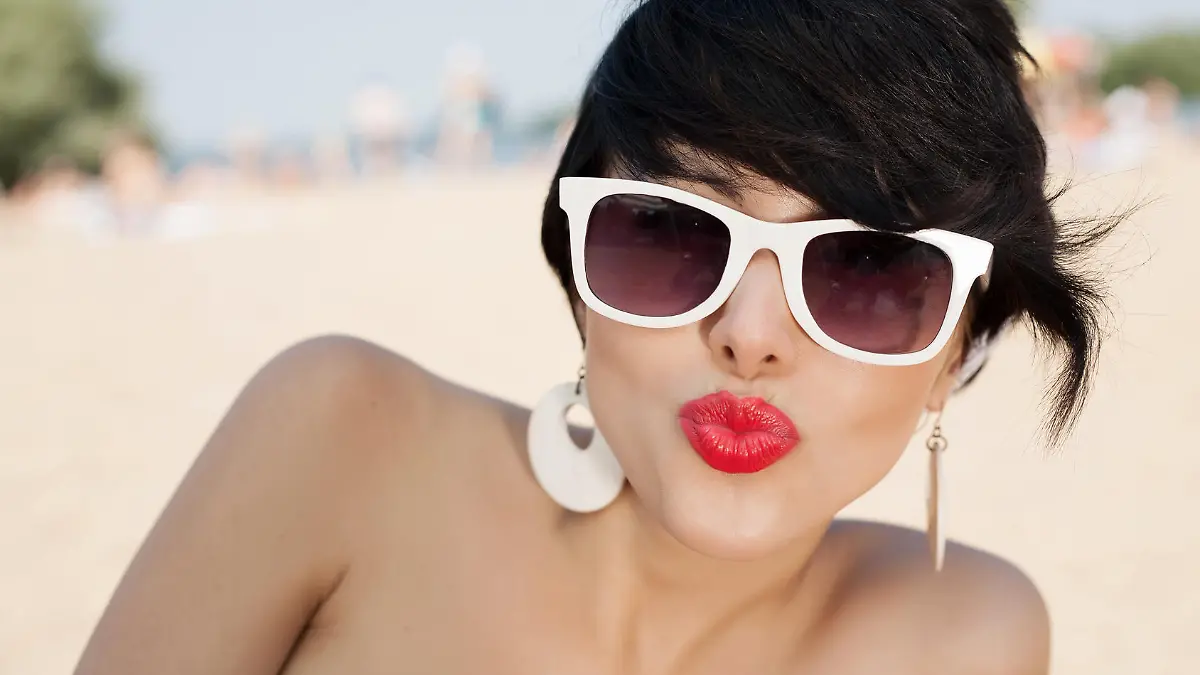 Beautiful sexy woman relaxing on the beach - outdoors