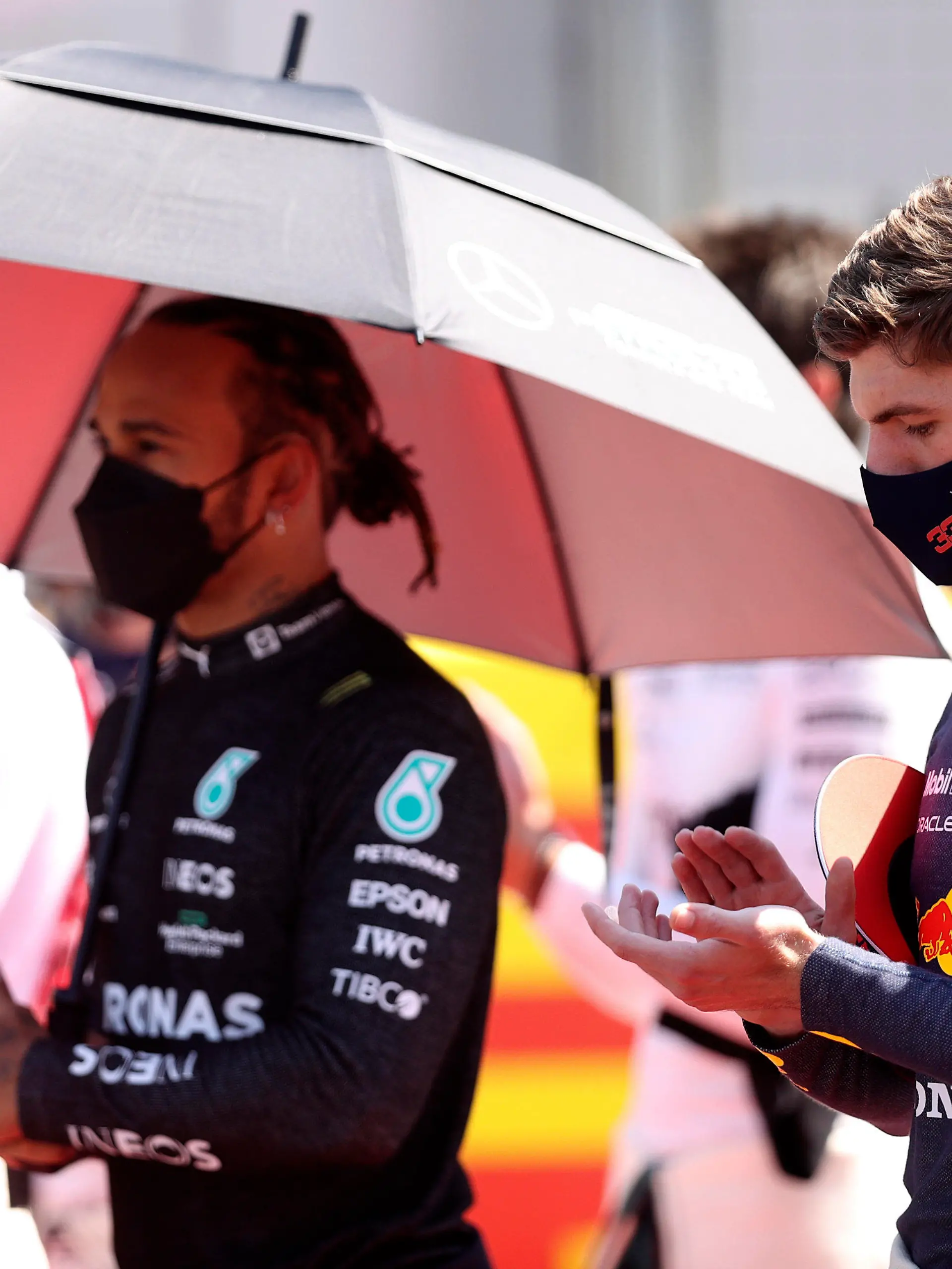Red Bull driver Max Verstappen of the Netherlands and Mercedes driver Lewis Hamilton of Britain, left, stand on the grid before the start of the British Formula One Grand Prix, at the Silverstone circuit, in Silverstone, England, Sunday, July 18, 2021. (Lars Baron/Pool photo via AP)
