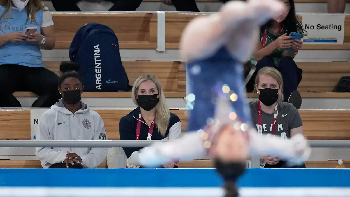 29.07.2021, Japan, Tokio: Turnen: Olympia, Mehrkampf, Frauen, Finale im Ariake Gymnastics Centre. Turnerin Simone Biles aus den USA (l) sieht ihrer Teamkollegin Sunisa Lee am Stufenbarren zu. Foto: Ashley Landis/AP/dpa +++ dpa-Bildfunk +++