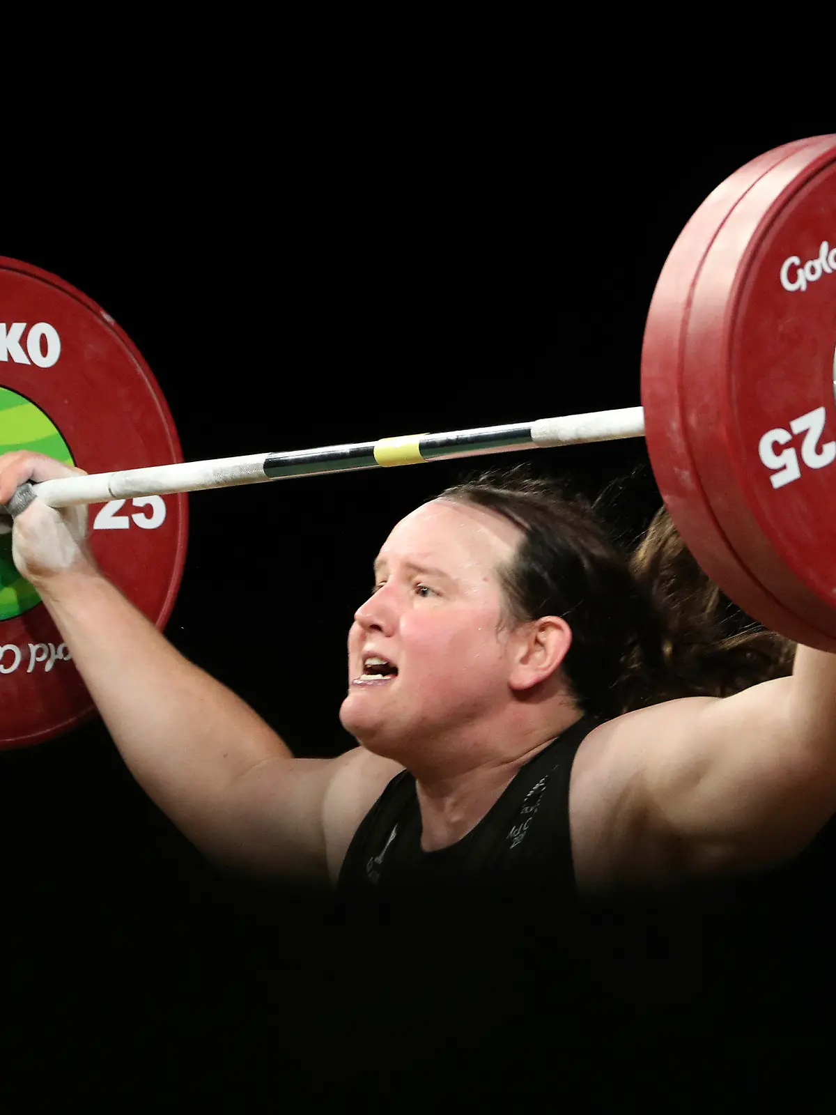 FILE - In this April 9, 2018, file photo, New Zealand's Laurel Hubbard lifts in the snatch of the women's 90kg weightlifting final at the 2018 Commonwealth Games on the Gold Coast, Australia. Hubbard, a transgender woman, is competing in weightlifting for New Zealand (AP Photo/Mark Schiefelbein, File)