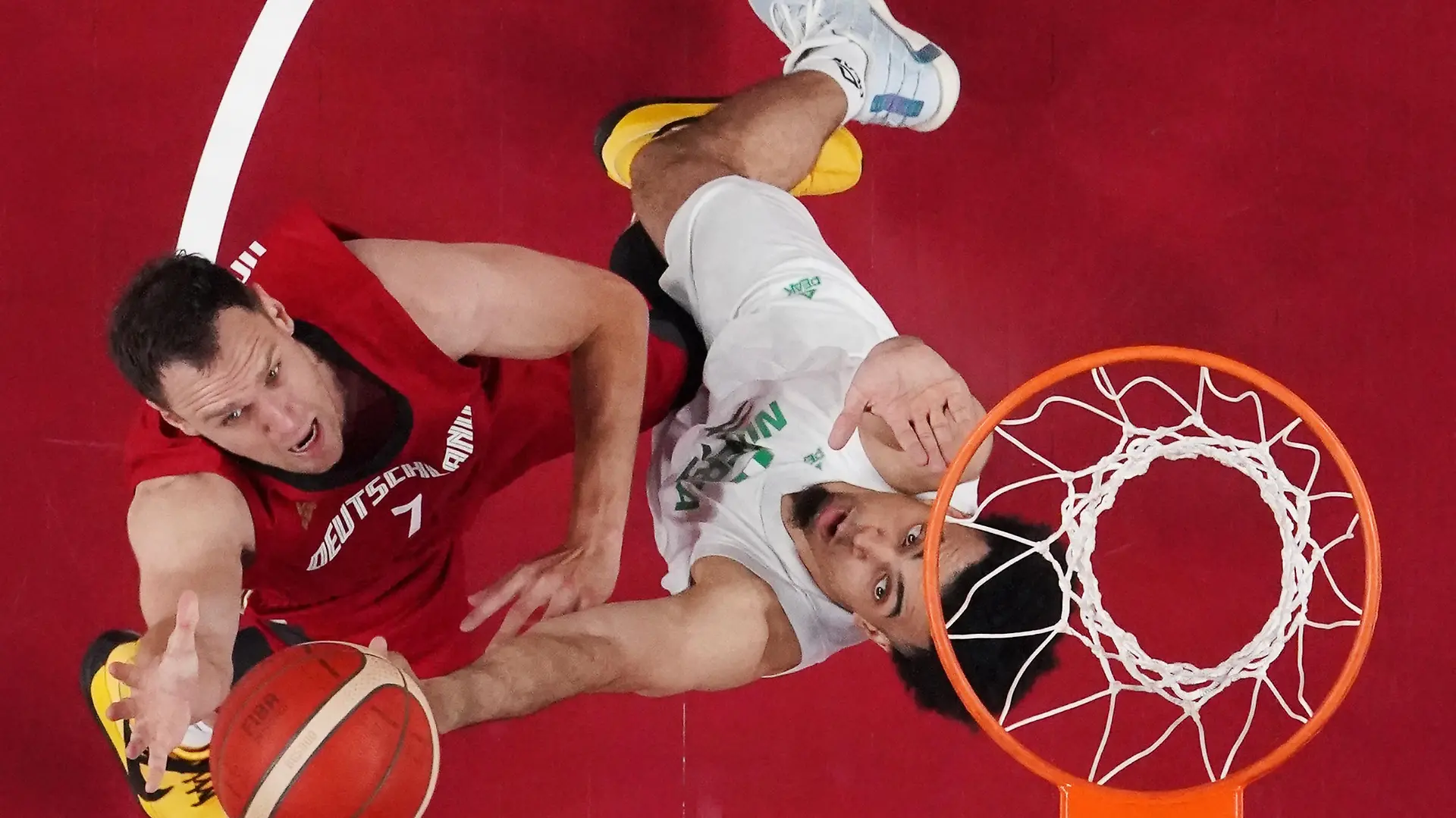 Tokyo 2020 Olympics - Basketball - Men - Group B - Nigeria v Germany - Saitama Super Arena, Saitama, Japan - July 28, 2021. Johannes Voigtmann of Germany in action with Jordan Nwora of Nigeria REUTERS/Brian Snyder