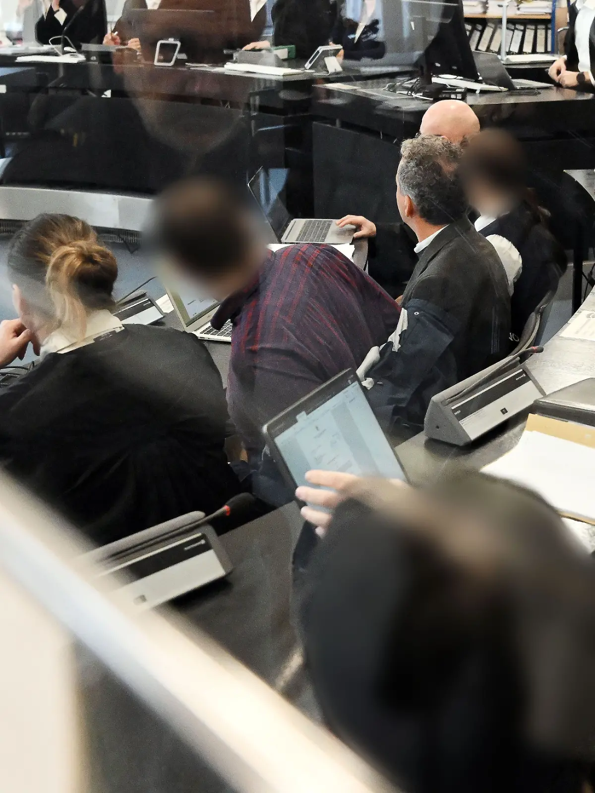 29.01.2026, Baden-Württemberg, Karlsruhe: Blick auf die Anklagebank im Schwurgerichtssaal des Landgerichts zu einem Prozess wegen eines tödlichen Brands in einer Pforzheimer Klinik. Ein Patient verbrannte in der Klinik, weil er auf seiner Liege mit Gurten fixiert war. Zwei Ärzte und zwei Pflegekräfte sind wegen fahrlässiger Tötung angeklagt. Einem der Angeklagten wird auch Freiheitsberaubung mit Todesfolge vorgeworfen.