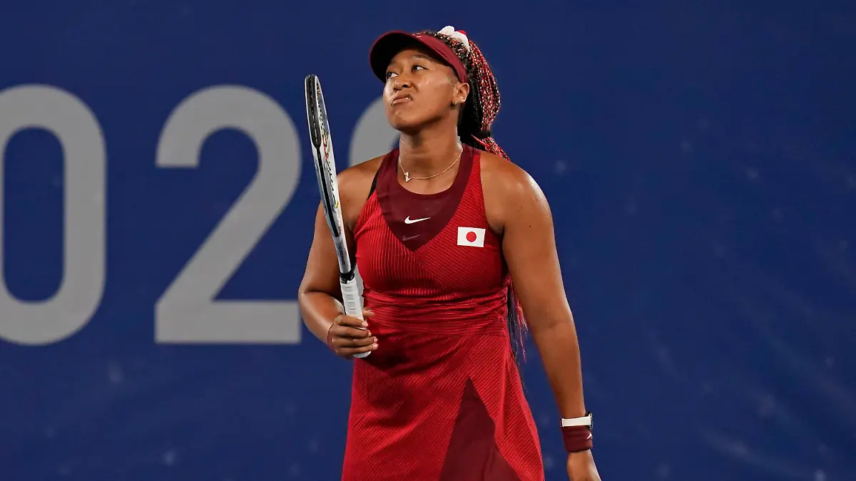 Naomi Osaka, of Japan, reacts after losing a point to Marketa Vondrousova, of the Czech Republic, during the third round of the tennis competition at the 2020 Summer Olympics, Tuesday, July 27, 2021, in Tokyo, Japan. (AP Photo/Seth Wenig)