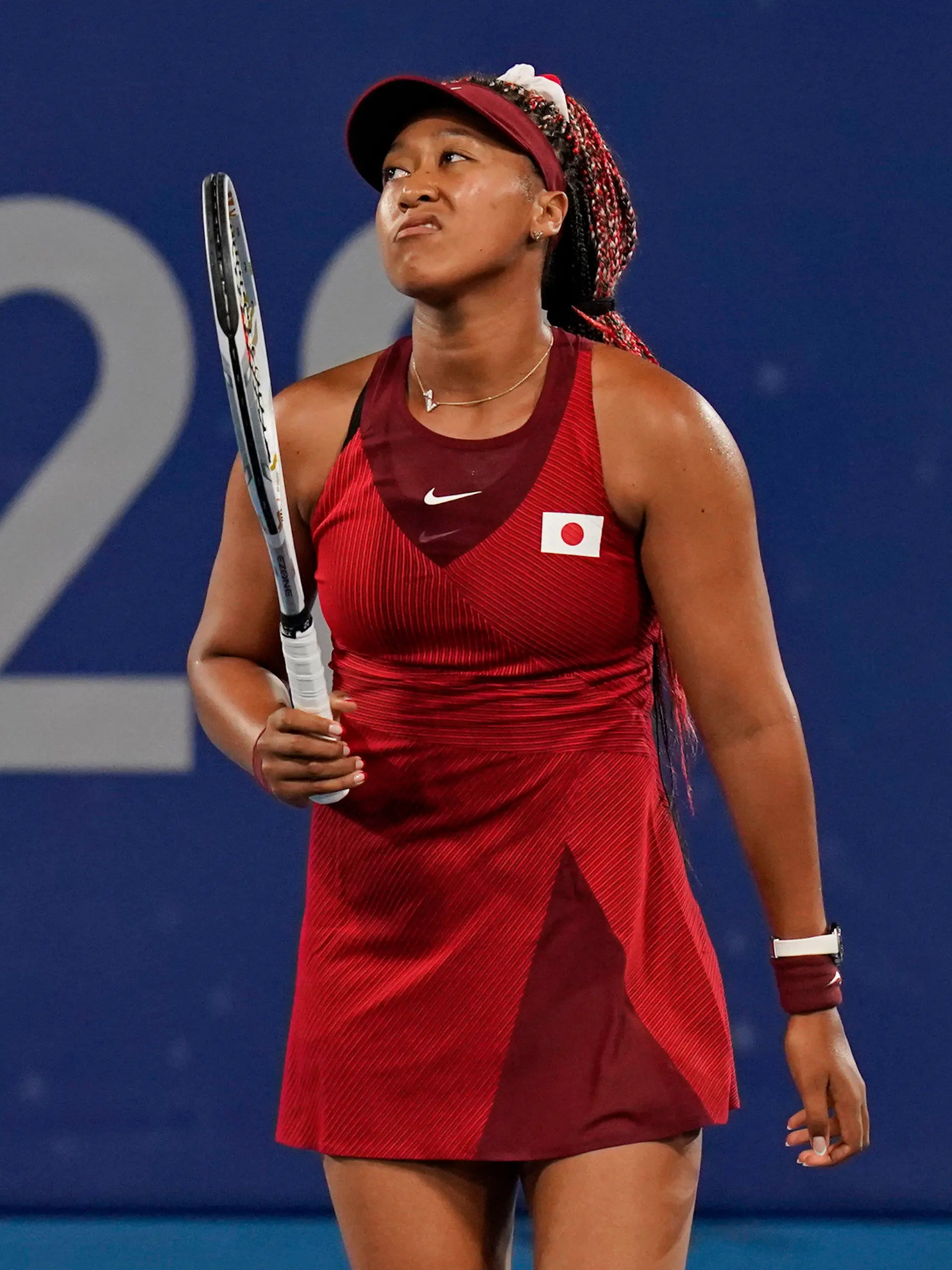 Naomi Osaka, of Japan, reacts after losing a point to Marketa Vondrousova, of the Czech Republic, during the third round of the tennis competition at the 2020 Summer Olympics, Tuesday, July 27, 2021, in Tokyo, Japan. (AP Photo/Seth Wenig)