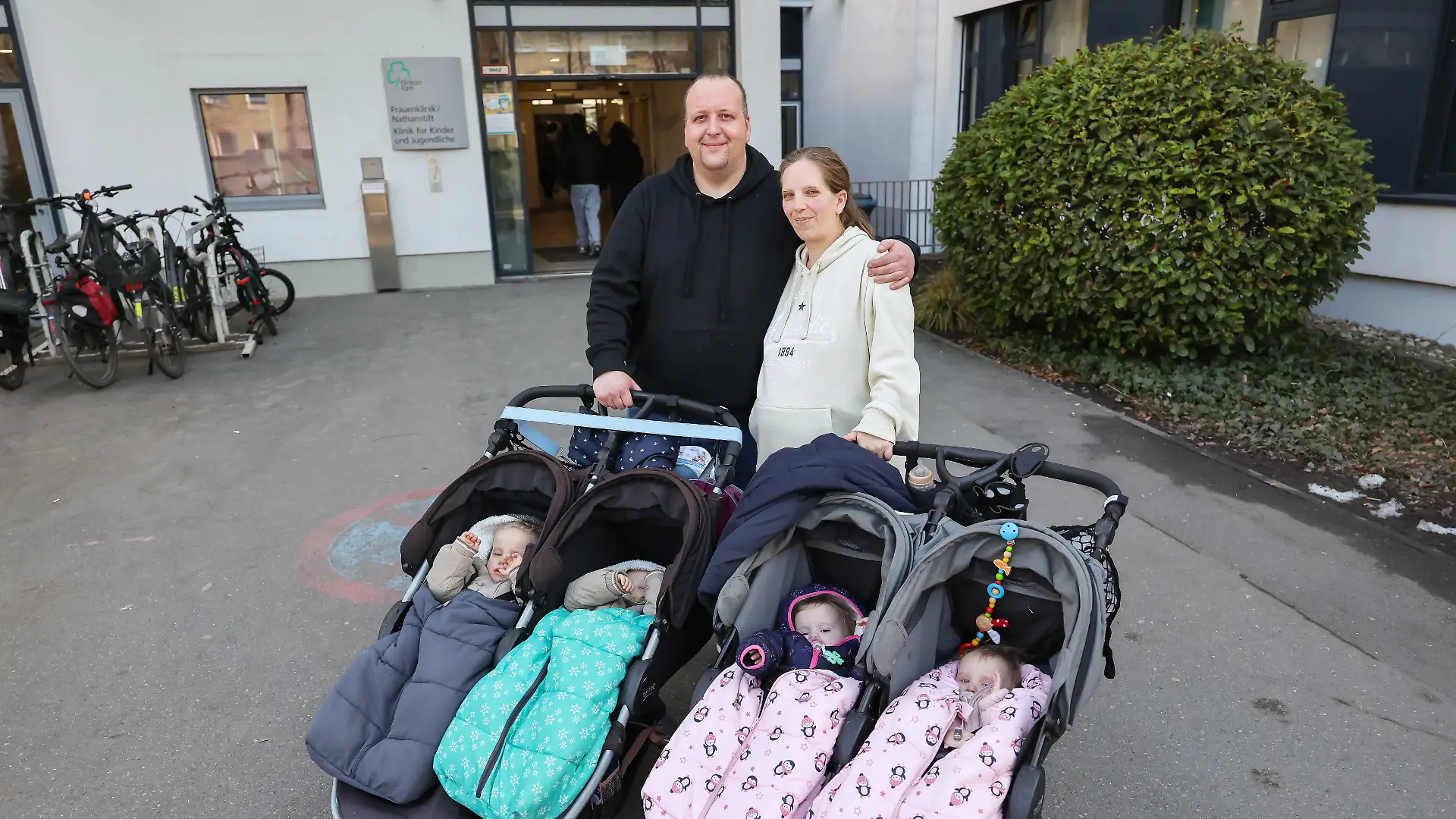 Andreas Rittner (l) und Jasmin Schmidt (r) verlassen mit ihren vier Kindern das Klinikum Fürth. Die Familie erwartet jetzt zum dritten Mal Zwillinge. 