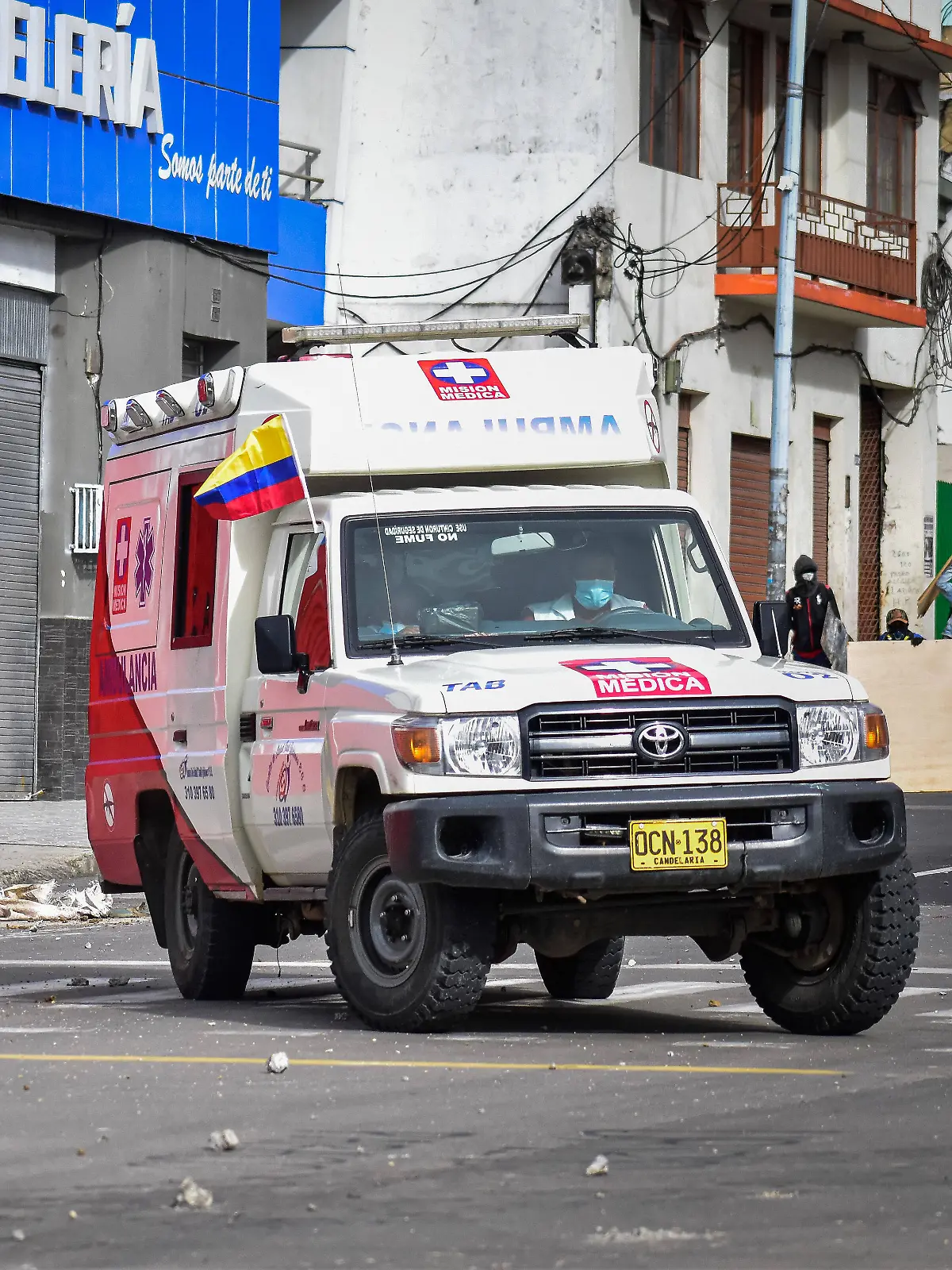 May 19, 2021, Pasto, Narino, Colombia: Ambulance crosses through clashes betwwn demostratos and police in Pasto, Narino