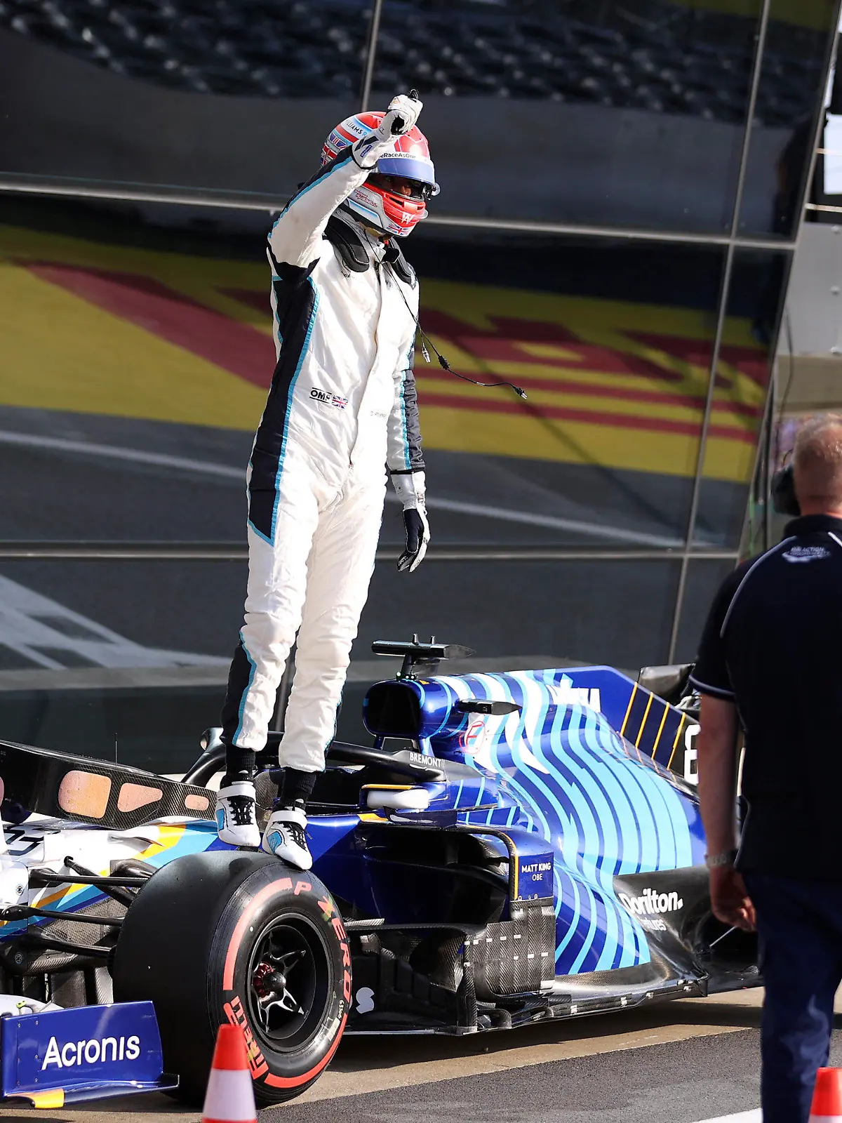 Williams driver George Russell of Britain waves to the fans at the end of the qualifying session ahead of Sunday's British Formula One Grand Prix, at the Silverstone circuit, in Silverstone, England, Friday, July 16, 2021. (Lars Baron/Pool photo via AP)