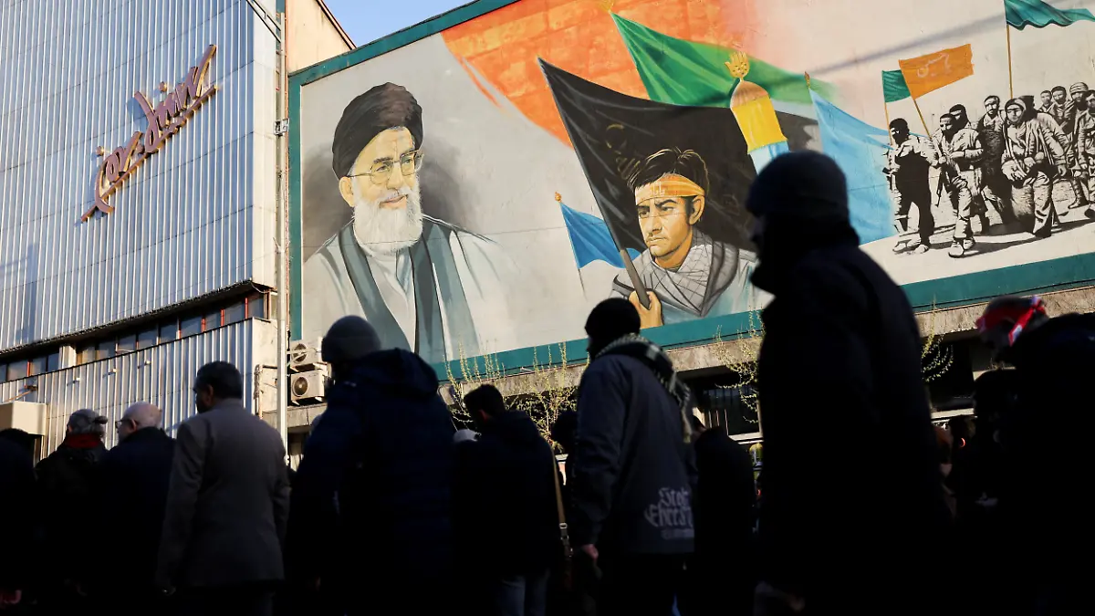 People walk near a mural featuring an image of Iran's Supreme Leader Ayatollah Ali Khamenei as people gather after Khamenei was killed in Israeli and U.S. strikes on Saturday, in Tehran, Iran, March 1, 2026. Majid Asgaripour/WANA (West Asia News Agency) via REUTERS ATTENTION EDITORS - THIS PICTURE WAS PROVIDED BY A THIRD PARTY