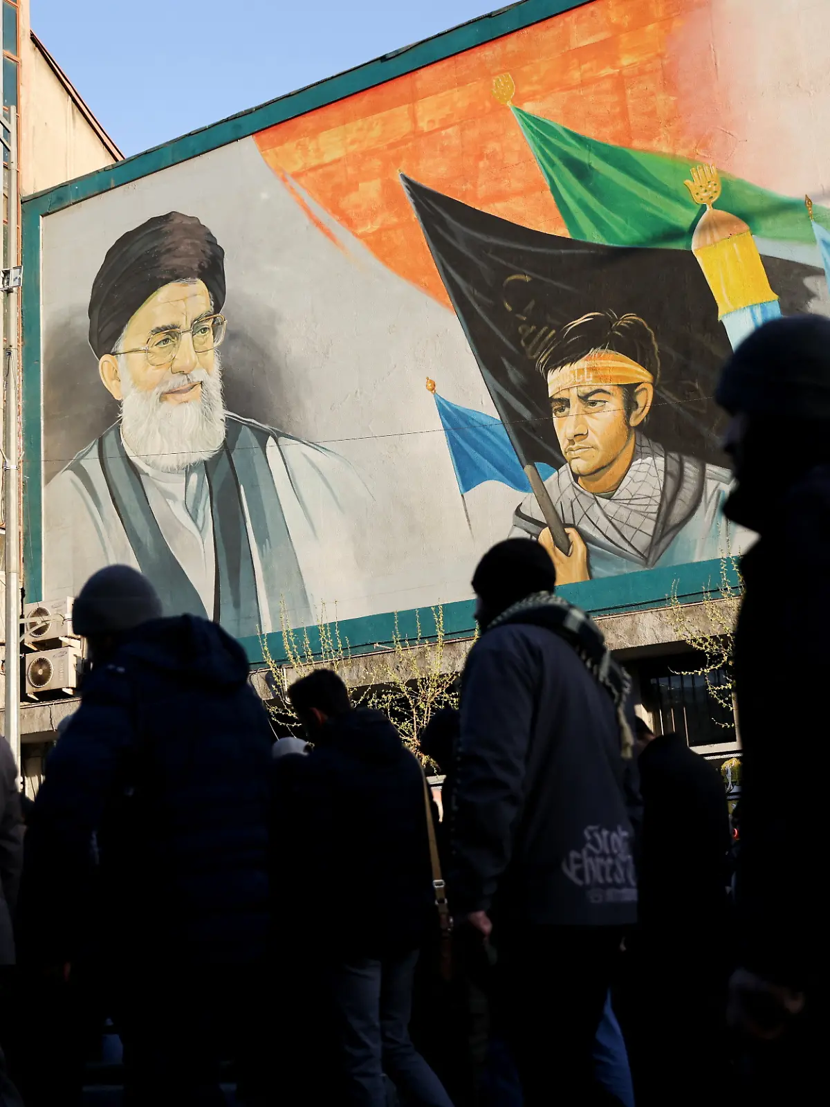 People walk near a mural featuring an image of Iran's Supreme Leader Ayatollah Ali Khamenei as people gather after Khamenei was killed in Israeli and U.S. strikes on Saturday, in Tehran, Iran, March 1, 2026. Majid Asgaripour/WANA (West Asia News Agency) via REUTERS  ATTENTION EDITORS - THIS PICTURE WAS PROVIDED BY A THIRD PARTY