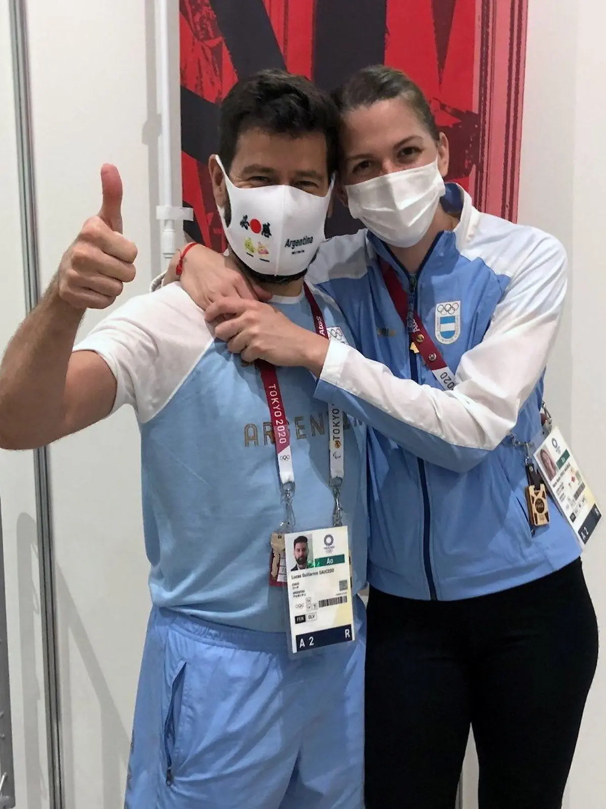 Argentine fencer Maria Belen Perez Maurice hugs her coach of 17 years, Lucas Guillermo Saucedo, after he proposed marriage to her on the sidelines of the Olympic fencing at Makuhari Messe Hall in Chiba, Japan July 26, 2021. Picture taken July 26, 2021. REUTERS/Sakura Murakami