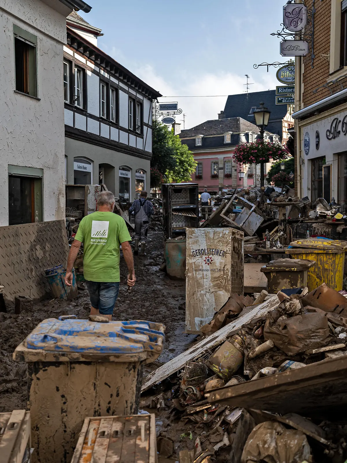  Aufräumarbeiten nach dem Hochwasser Menschen laufen durch die verwüstete Stadt Bad Neuenahr-Ahrweiler. Am 14.07.2021 kam es im Landkreis Ahrweiler zu starken Überflutungen durch Starkregen. Tage nach dem Hochwasser liefen Aufräumarbeiten an. Bundeswehr, Polizei, Feuerwehr und Freiwillige beteiligen sich daran. Bad Neuenahr-Ahrweiler Rheinland-Pfalz Deutschland *** Cleanup after the flood people walk through the devastated town of Bad Neuenahr Ahrweiler On 14 07 2021 there was heavy flooding in the district of Ahrweiler due to heavy rain Days after the flood, cleanup efforts were underway Bundeswehr, police, firefighters and volunteers participate Bad Neuenahr Ahrweiler Rhineland Palatinate Germany