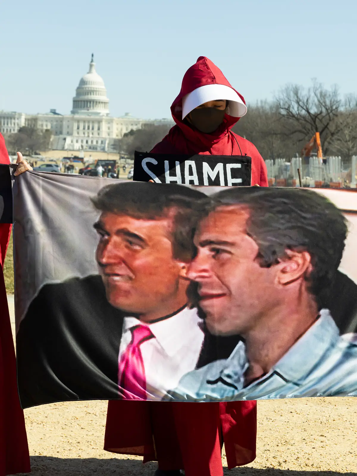 Demonstrators dressed as handmaids from The Handmaid's Tale hold a Trump-Epstein sign during the ''March 4 Democracy'' rally on the National Mall in Washington, DC, on February 28, 2026. On this day, US President Donald Trump announces that the United States and Israel launch major military strikes on Iran that kill Iran's Supreme Leader Ayatollah Ali Khamenei. (Photo by Aashish Kiphayet/NurPhoto)