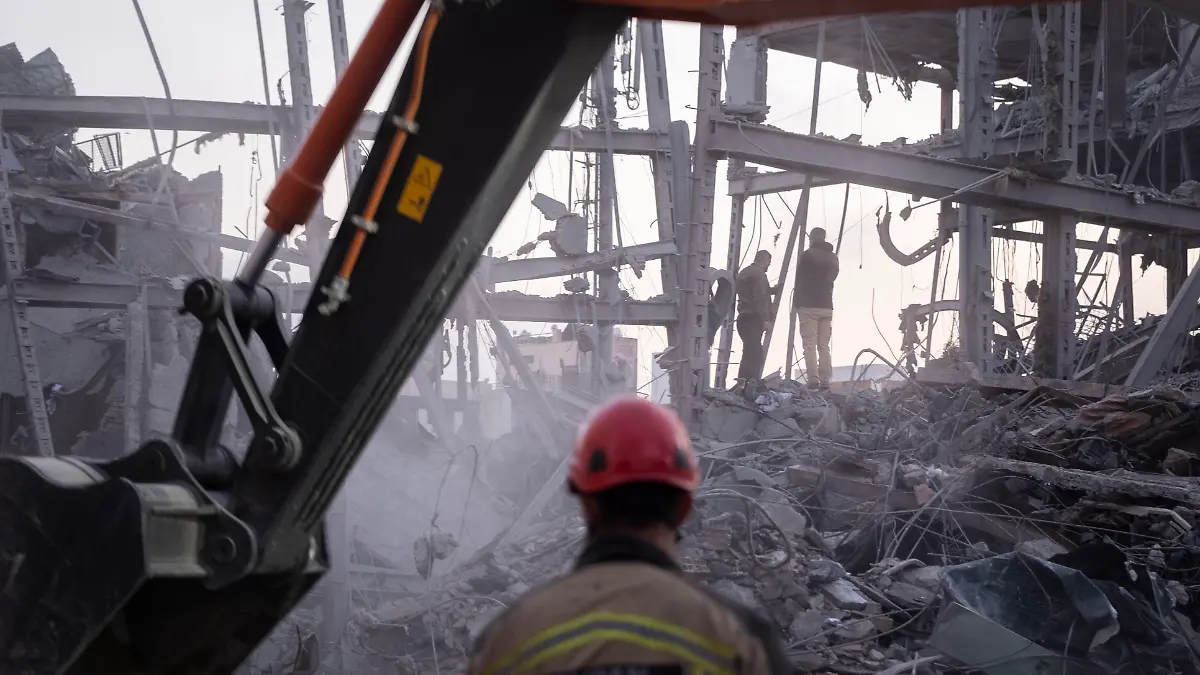 An Iranian firefighter and a loader work on the ruins of a police headquarters that is completely destroyed in U.S.-Israeli attacks in Tehran, Iran, on March 2, 2026. (Photo by Morteza Nikoubazl/NurPhoto)