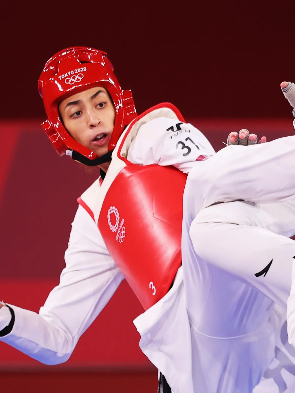 Tokyo 2020 Olympics - Taekwondo - Women's Featherweight 49-57kg - Quarterfinal - Makuhari Messe Hall A, Chiba, Japan - July 25, 2021. Kimia Alizadeh of the Refugee Olympic Team in action against Zhou Lijun of China REUTERS/Murad Sezer