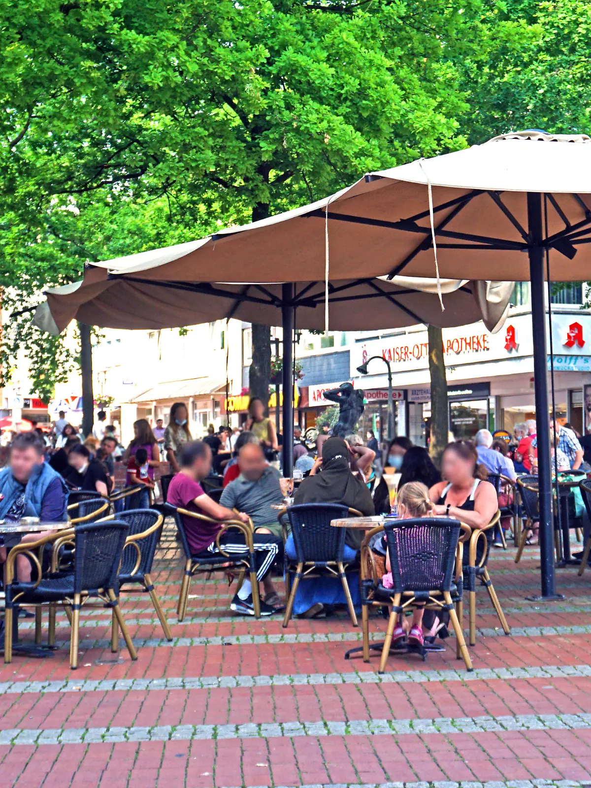 Außenbewirtung in einem Eiscafé bei sonnigem Wetter in Essen