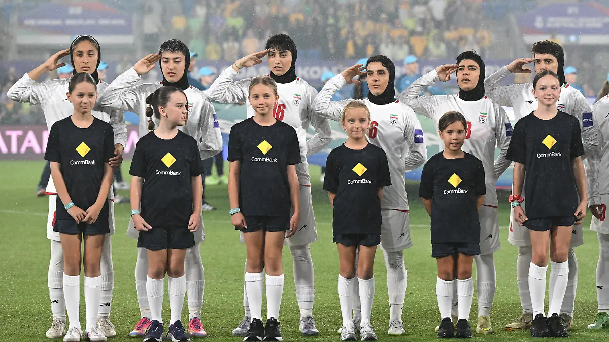 Iran players react during their national anthem ahead of the Women's Asia Cup soccer match between Australia and Iran in Robina, Australia, Thursday, March 5, 2026. (Dave Hunt/AAPImage via AP)