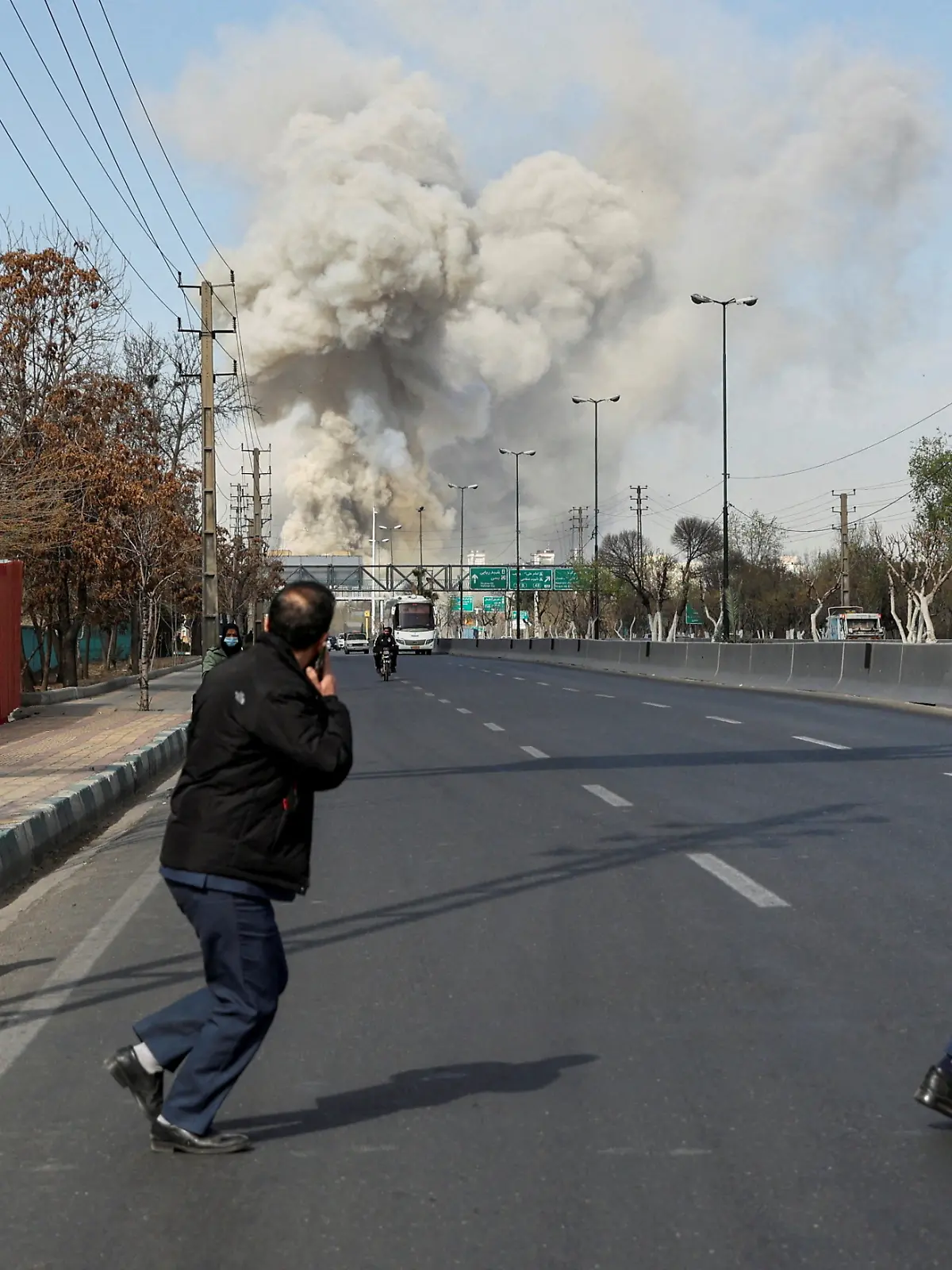 People run as smoke rises following an explosion, amid the U.S.-Israeli conflict with Iran, in Tehran, Iran, March 5, 2026. Majid Asgaripour/WANA (West Asia News Agency) via REUTERS ATTENTION EDITORS - THIS PICTURE WAS PROVIDED BY A THIRD PARTY        TPX IMAGES OF THE DAY