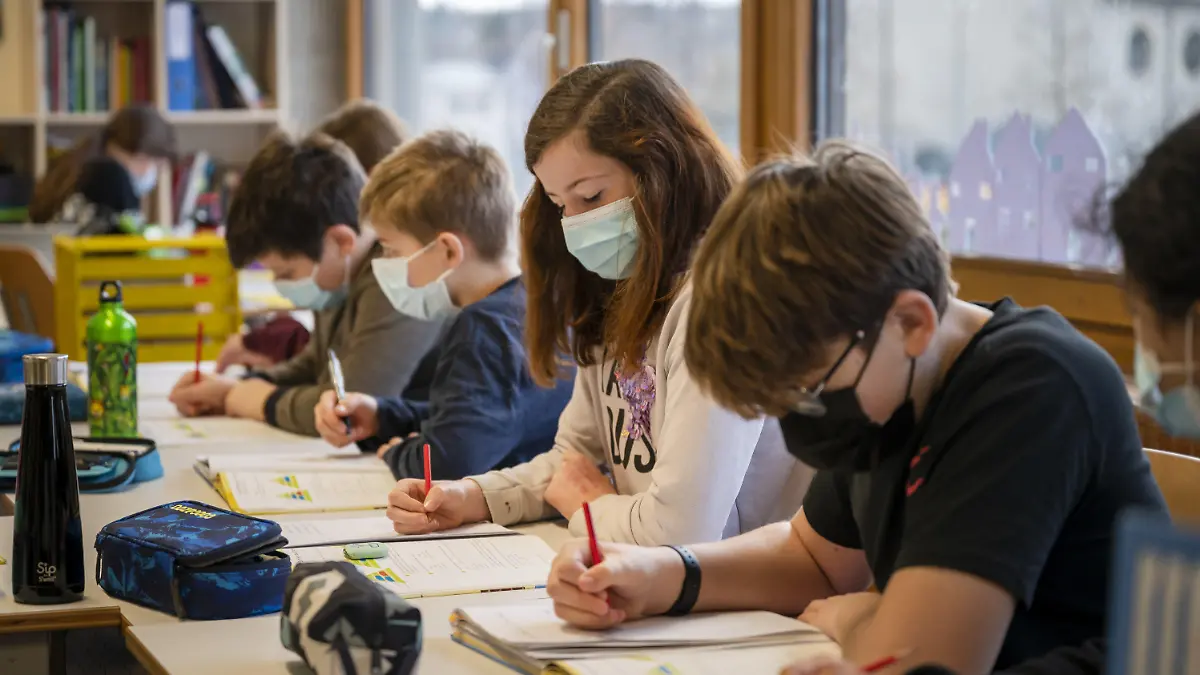 21.01.2021, Schweiz, Allschwil: Primarschüler einer sechsten Klasse tragen im Unterricht Gesichtsmasken im Schulhaus Neuallschwil in Allschwil. Im Kanton Basel-Landschaft müssen Schulkinder ab zehn Jahren wegen der Corona-Pandemie eine Maske tragen. Foto: Georgios Kefalas/KEYSTONE/dpa - ACHTUNG: Nur zur redaktionellen Verwendung im Zusammenhang mit der aktuellen Berichterstattung und nur mit vollständiger Nennung des vorstehenden Credits +++ dpa-Bildfunk +++