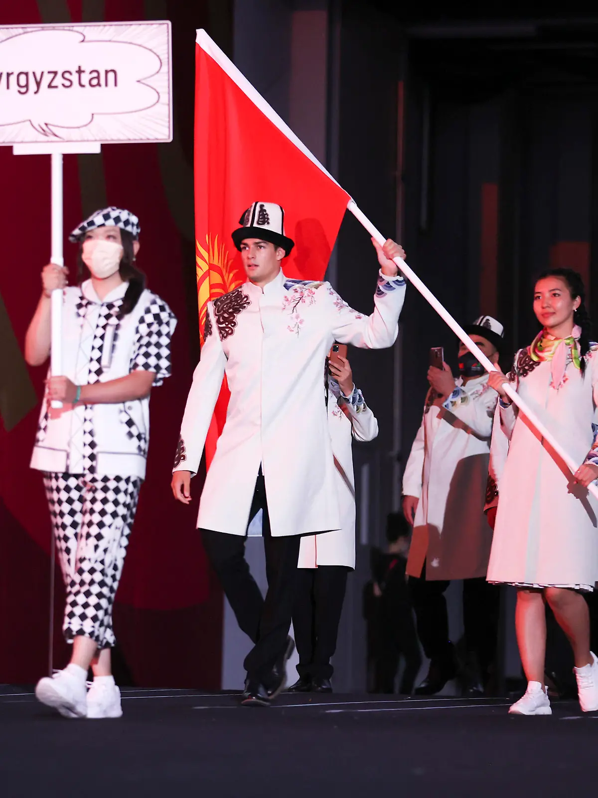 TOKYO, JAPAN - JULY 23: Flag bearers Kanykei Kubanychbekova and Denis Petrashov of Team Kyrgyzstan during the Opening Ceremony of the Tokyo 2020 Olympic Games at Olympic Stadium on July 23, 2021 in Tokyo, Japan. (Photo by Jamie Squire/Getty Images)