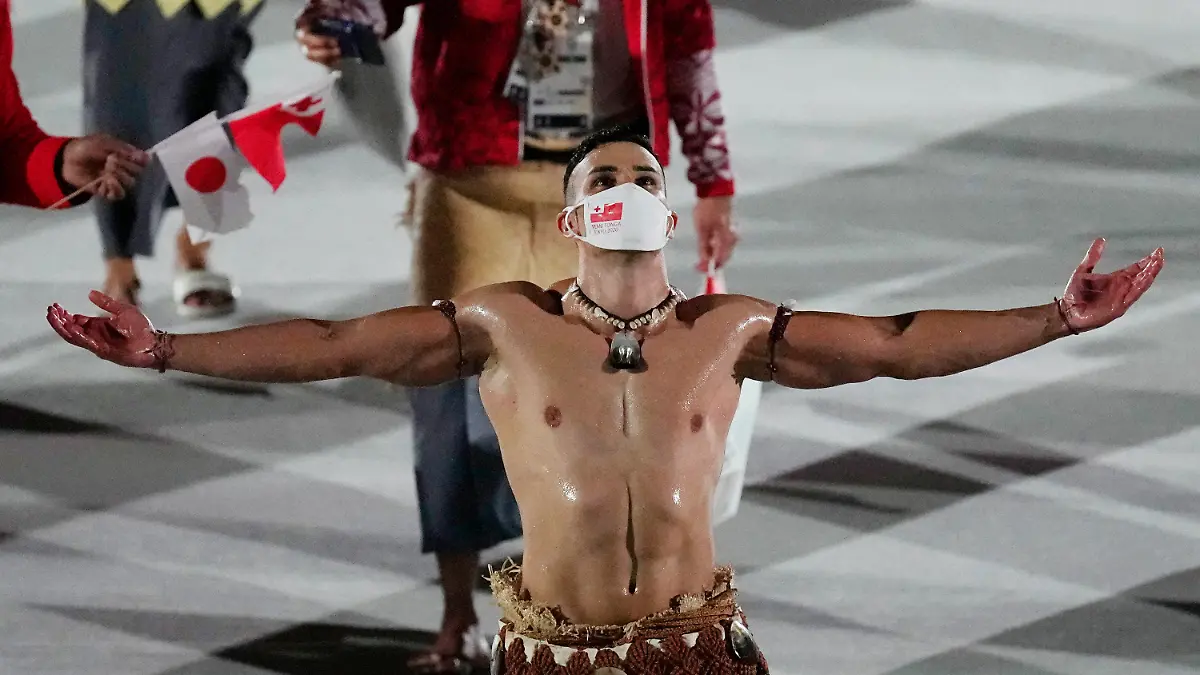 Pita Taufatofua, of Tonga, walks during the opening ceremony in the Olympic Stadium at the 2020 Summer Olympics, Friday, July 23, 2021, in Tokyo, Japan. (AP Photo/David J. Phillip)
