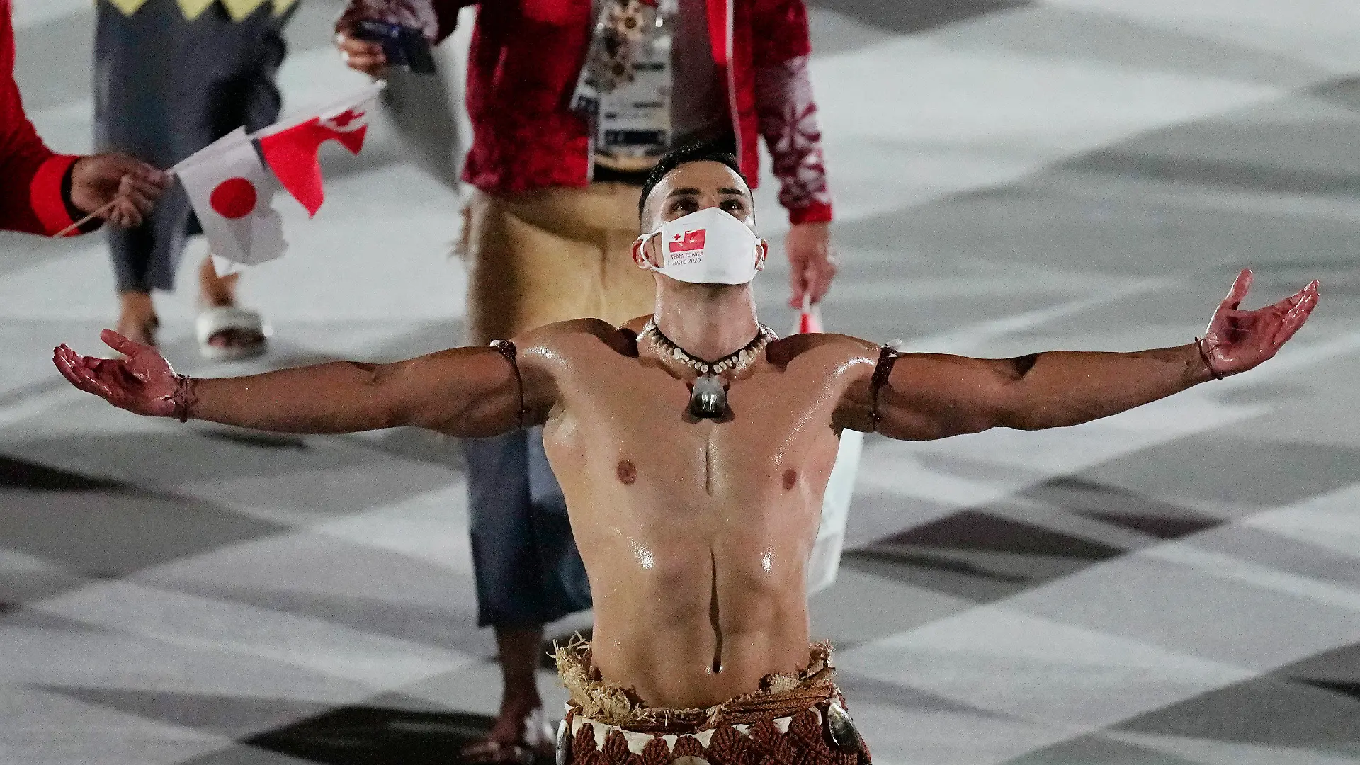 Pita Taufatofua, of Tonga, walks during the opening ceremony in the Olympic Stadium at the 2020 Summer Olympics, Friday, July 23, 2021, in Tokyo, Japan. (AP Photo/David J. Phillip)
