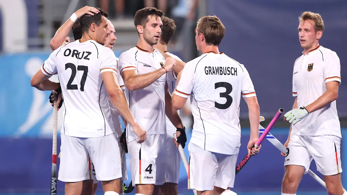 TOKYO, JAPAN - JULY 24: Lukas Windfeder of Team Germany celebrates with teammate Mats Jurgen Grambusch after scoring their team's fourth goal during the Men's Preliminary Pool B match between Canada and Germany on day one of the Tokyo 2020 Olympic Games at Oi Hockey Stadium on July 24, 2021 in Tokyo, Japan. (Photo by Alexander Hassenstein/Getty Images)